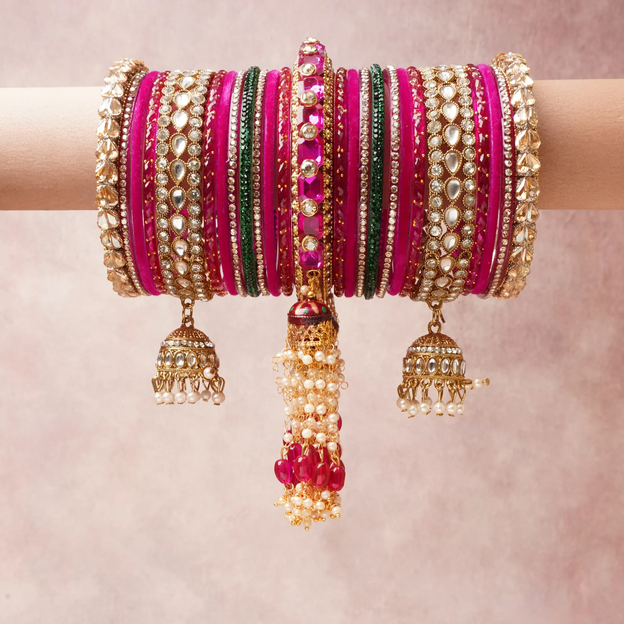The Femminari Crown- Jewellery beyond luxury. A crown colour Fuchsia Pink set, complemented by Emerald Green, Clear Crystal, Champagne Glass, featuring Gold-plated Base Metal, Kundan, Crystal, Faceted Glass, Velvet, Pearls. A treat for the eyes, hands and heart- absolutely unforgettable.