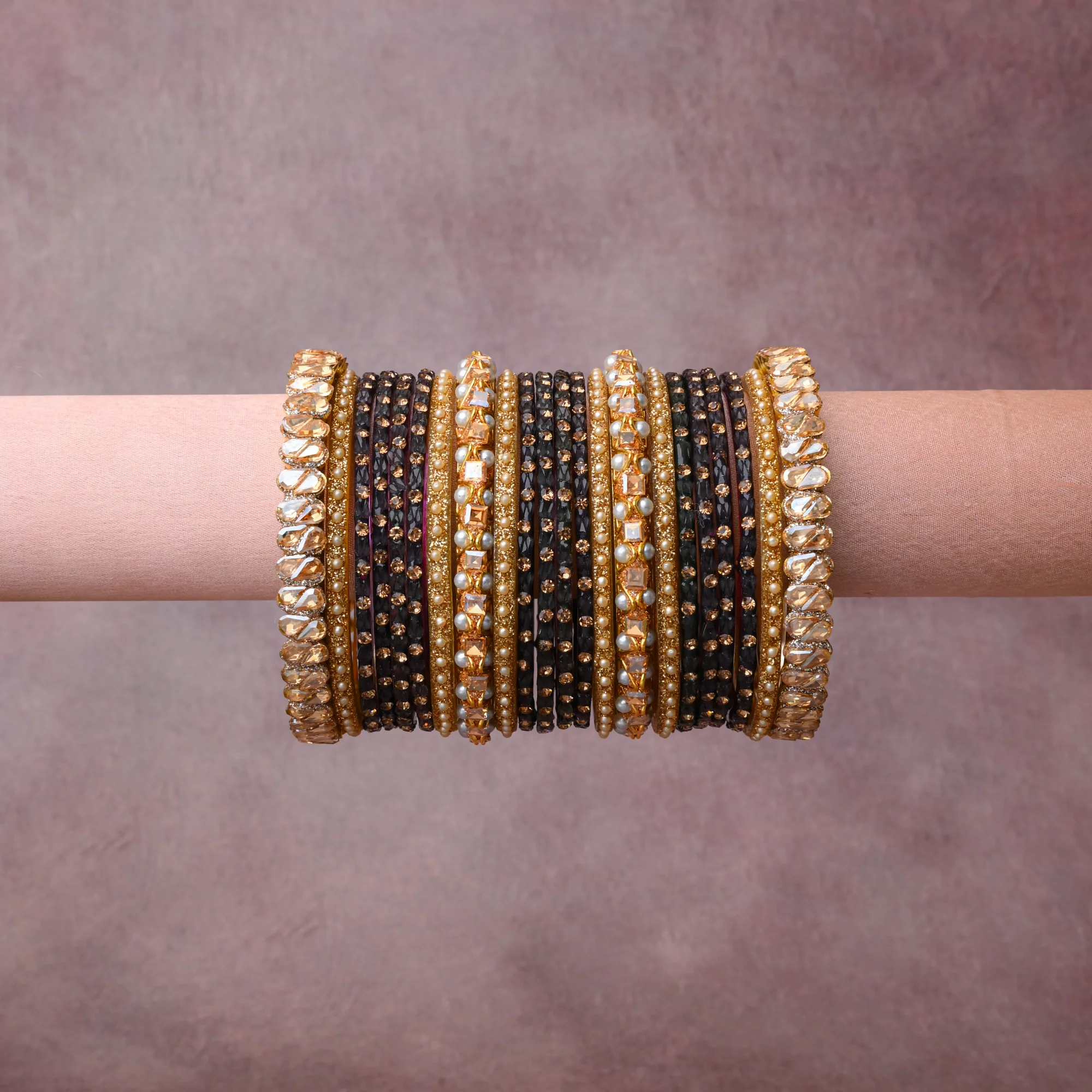 A grounding Black forms the heart of the set, while touches of Amber, Champagne, Cream add charm.

A thoughtful composition of Gold-toned Alloy, Faceted Glass, Imitation Pearls, designed to feel complete without being heavy.
Each element layers seamlessly, creating a look that is refined, wearable and quietly striking.