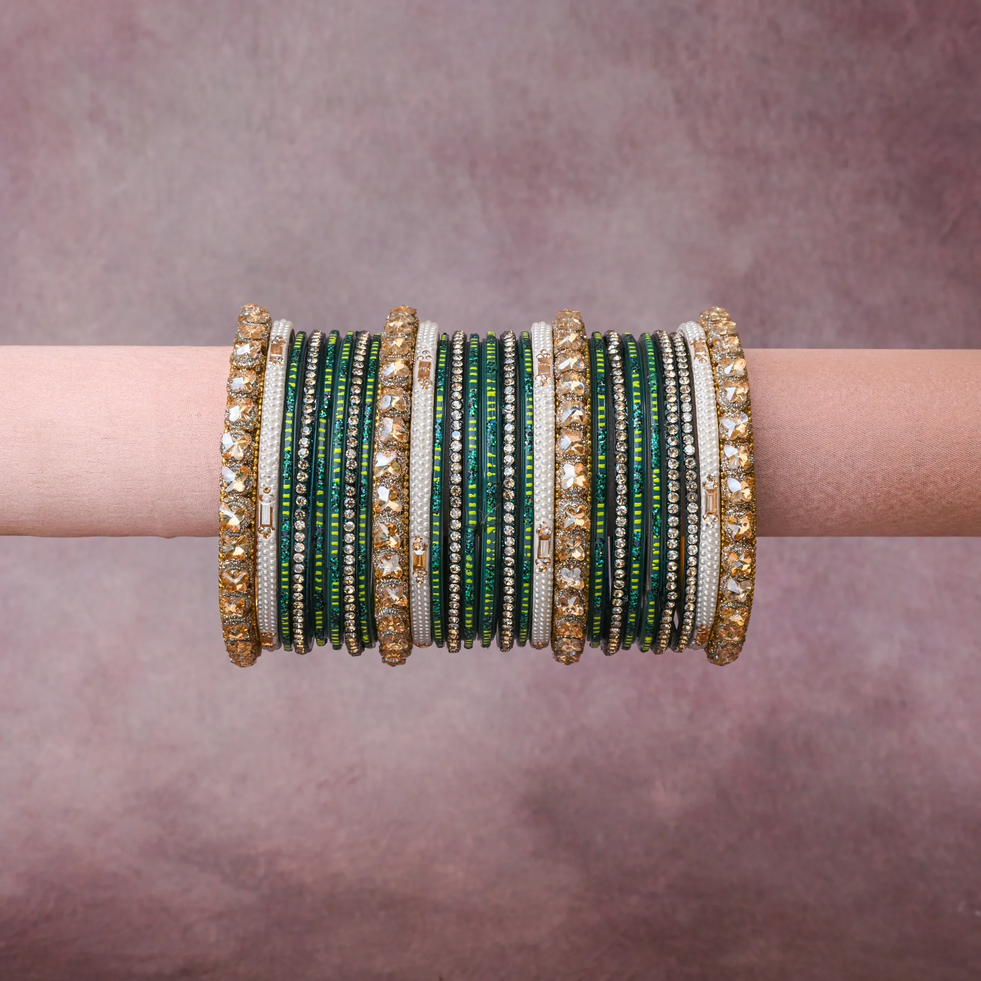 A grounding Deep Emerald Green forms the heart of the set, while touches of Champagne Gold, Clear Crystal, Pearlescent White, Lime Green, Metallic Gold add charm.

A thoughtful composition of Glass, Faceted Glass Crystals, Crystal Rhinestones, Imitation Pearls, Gold-Toned Base Metal, Lacquer/Enamel, Silk Thread, designed to feel complete without being heavy.
Each element layers seamlessly, creating a look that is refined, wearable and quietly striking.