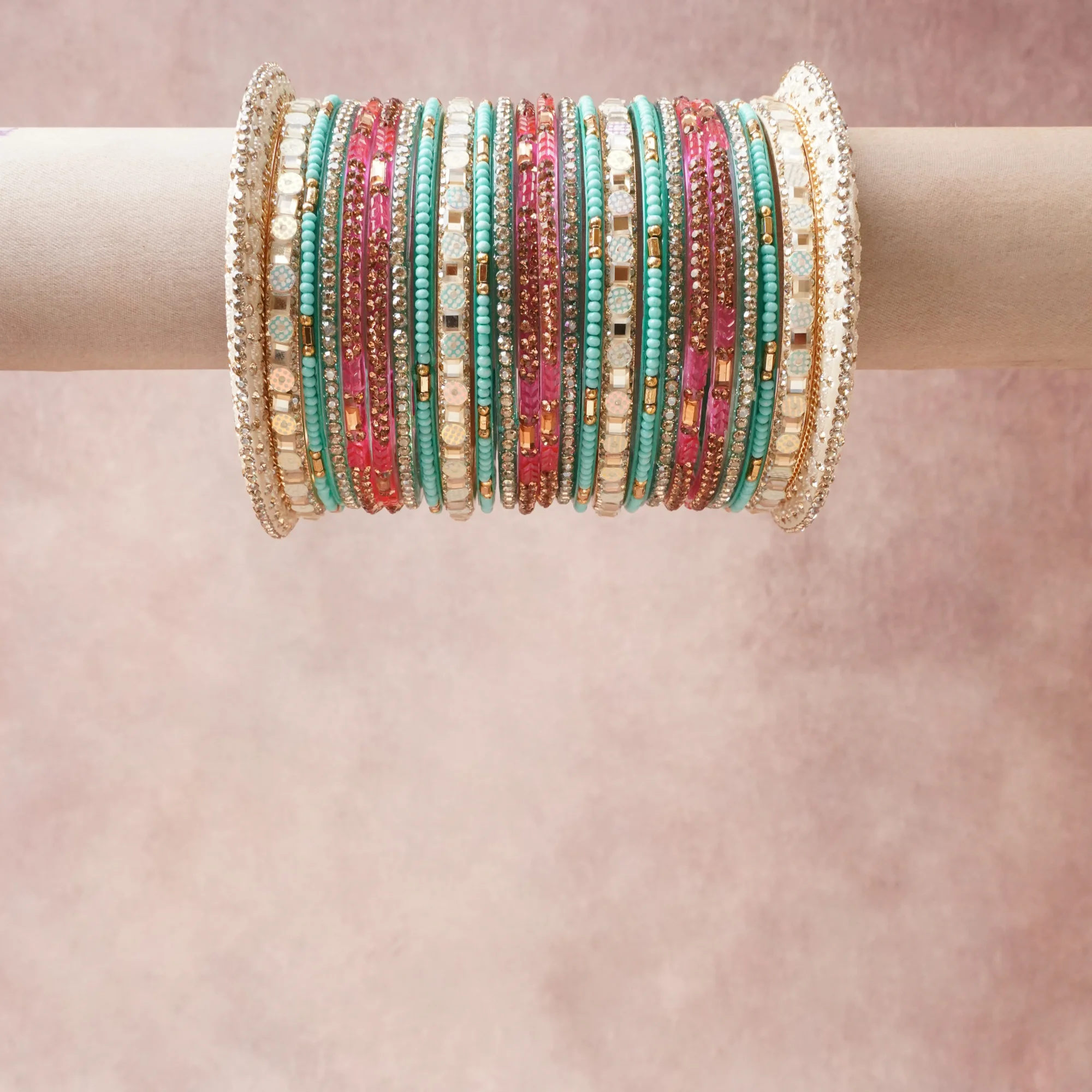 A grounding Teal forms the heart of the set, while touches of Clear Crystal, Metallic Gold, Iridescent White, Fuchsia add charm.

A thoughtful composition of Glass Beads, Crystal Rhinestones, Gold-Toned Metal, Lacquer, Synthetic Opal Simulant, designed to feel complete without being heavy.
Each element layers seamlessly, creating a look that is refined, wearable and quietly striking.