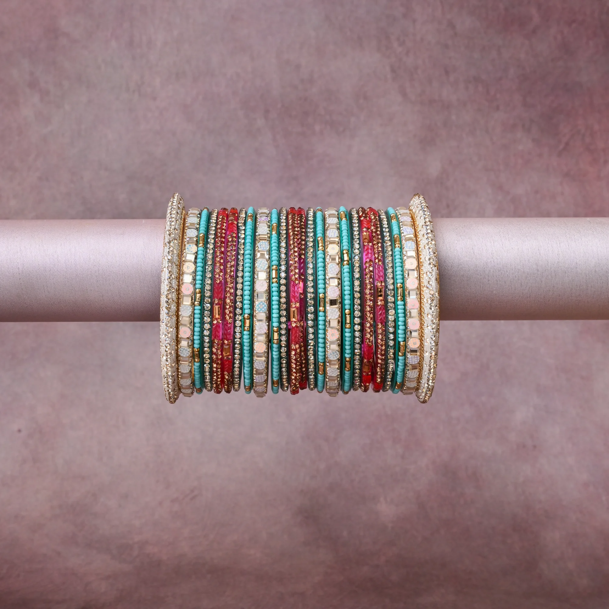 A grounding Teal forms the heart of the set, while touches of Clear Crystal, Metallic Gold, Iridescent White, Fuchsia add charm.

A thoughtful composition of Glass Beads, Crystal Rhinestones, Gold-Toned Metal, Lacquer, Synthetic Opal Simulant, designed to feel complete without being heavy.
Each element layers seamlessly, creating a look that is refined, wearable and quietly striking.