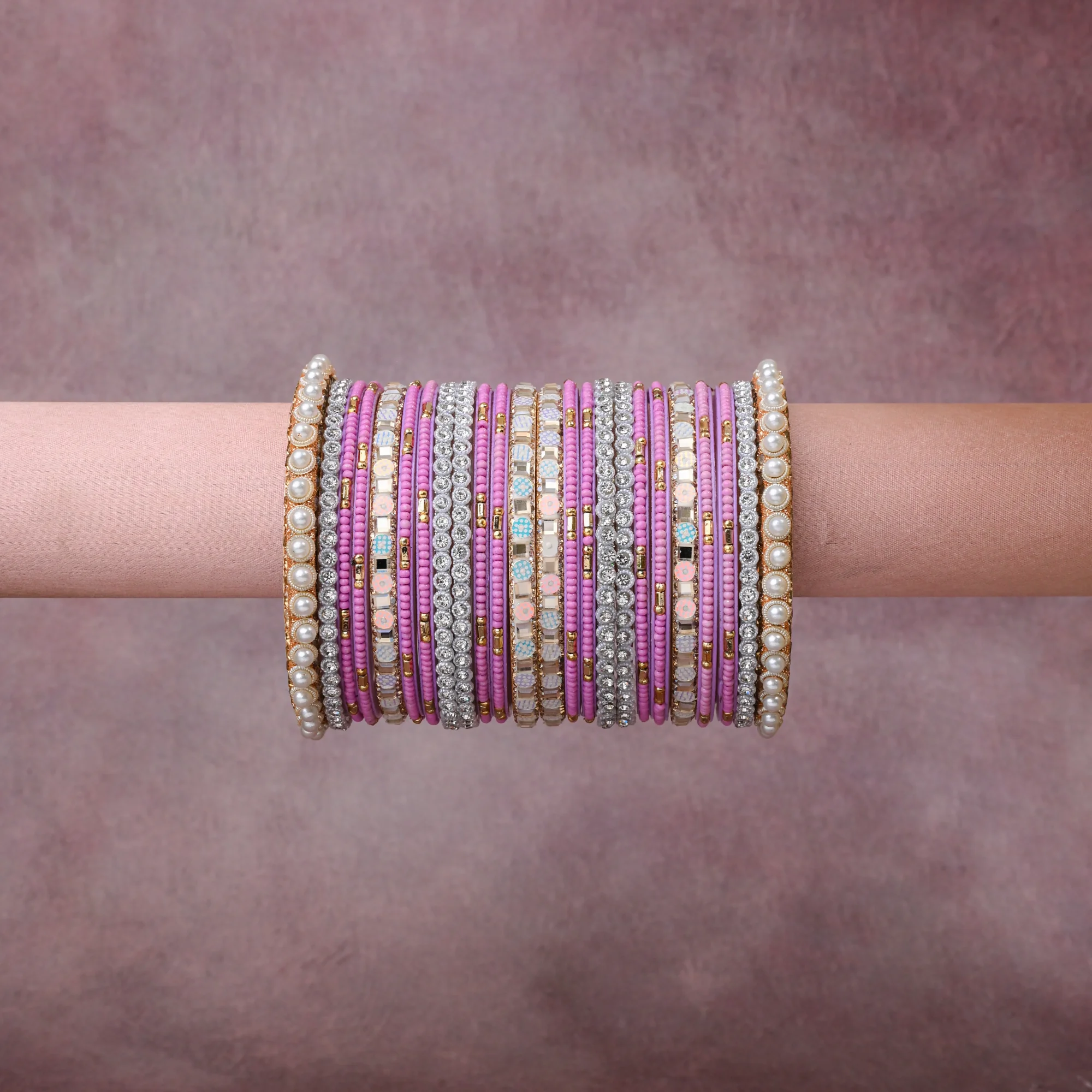 A grounding Orchid Pink forms the heart of the set, while touches of Pearlescent White, Silver, Gold, Pastel Blue, Pale Peach add charm.

A thoughtful composition of Glass, Rhinestones, Simulated Pearls, Gold-Toned Metal, Silver-Toned Metal, Enamel/Resin, designed to feel complete without being heavy.
Each element layers seamlessly, creating a look that is refined, wearable and quietly striking.