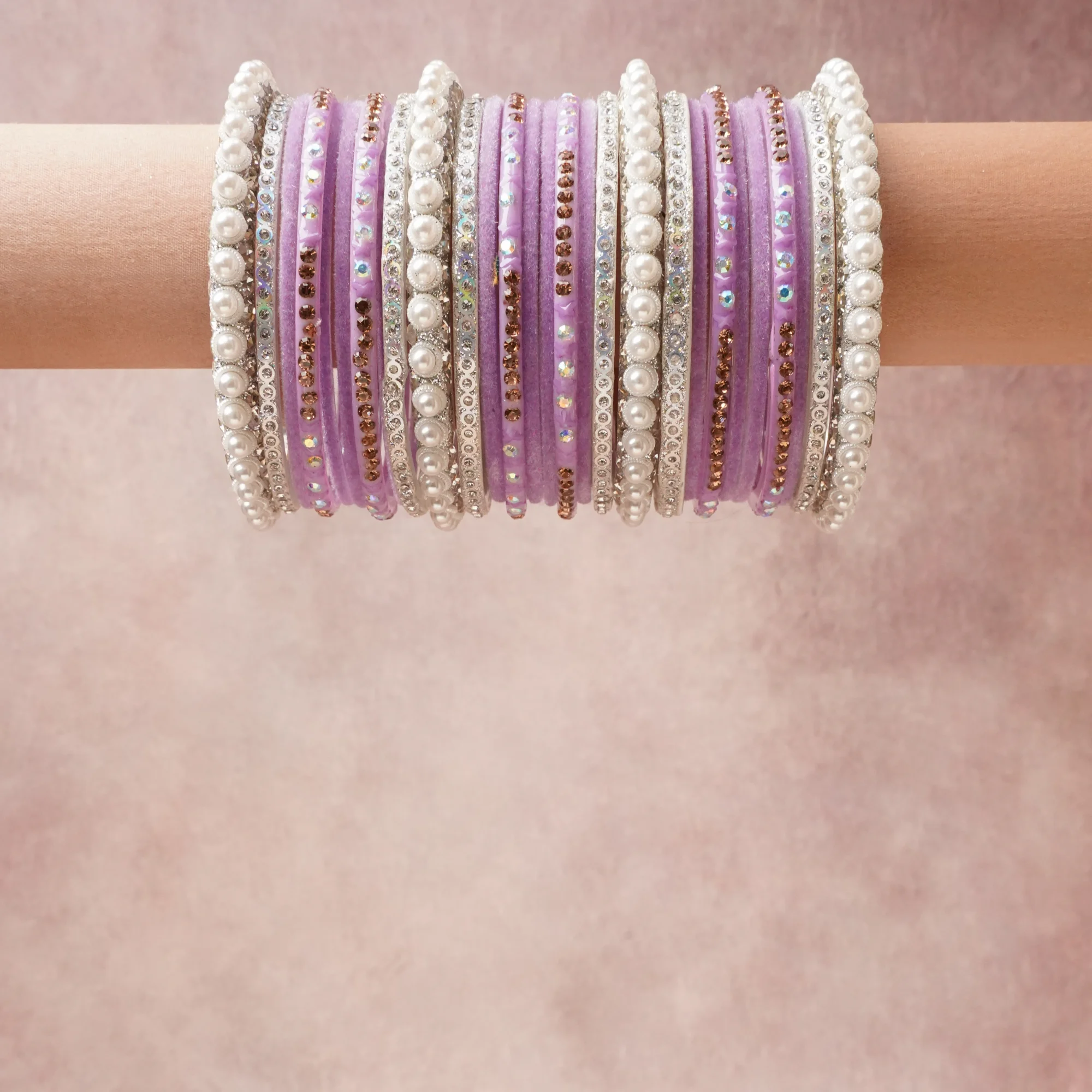A grounding Lavender forms the heart of the set, while touches of Pearl White, Silver, Amber add charm.

A thoughtful composition of Resin/Glass, Velvet, Simulated Pearls, Silver-toned Metal, Rhinestones (Clear, Amber, Iridescent), designed to feel complete without being heavy.
Each element layers seamlessly, creating a look that is refined, wearable and quietly striking.