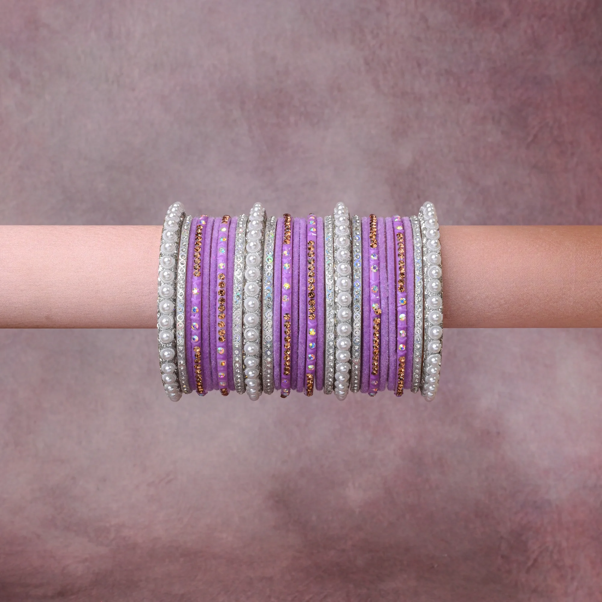 A grounding Lavender forms the heart of the set, while touches of Pearl White, Silver, Amber add charm.

A thoughtful composition of Resin/Glass, Velvet, Simulated Pearls, Silver-toned Metal, Rhinestones (Clear, Amber, Iridescent), designed to feel complete without being heavy.
Each element layers seamlessly, creating a look that is refined, wearable and quietly striking.