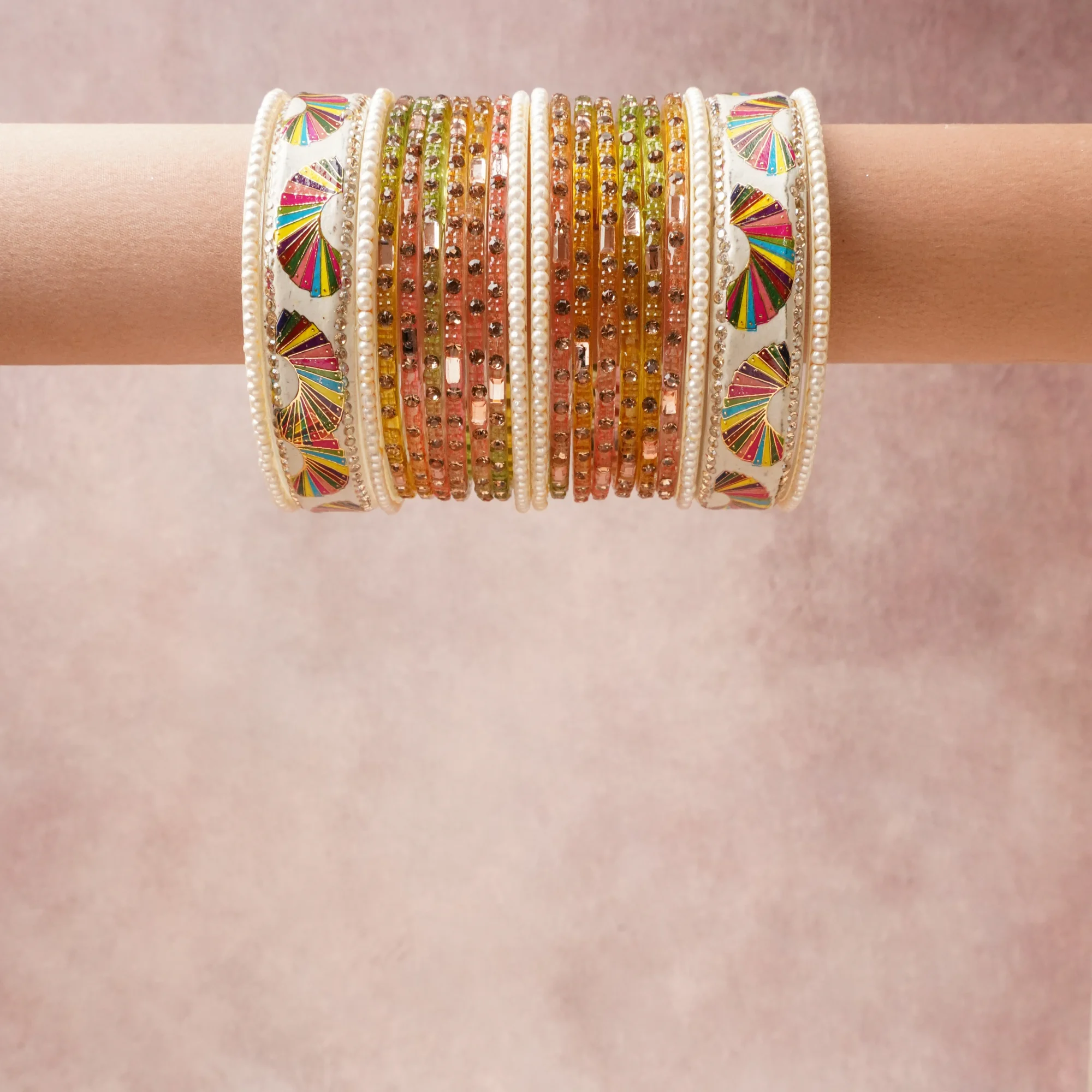 A grounding Ivory forms the heart of the set, while touches of Magenta, Scarlet, Marigold, Lime Green, Teal, Royal Blue, Metallic Gold, Champagne Crystal, Pearl White add charm.

A thoughtful composition of Lacquer, Glass, Faux Pearls, Crystal Rhinestones, Gold-Toned Metal, designed to feel complete without being heavy.
Each element layers seamlessly, creating a look that is refined, wearable and quietly striking.