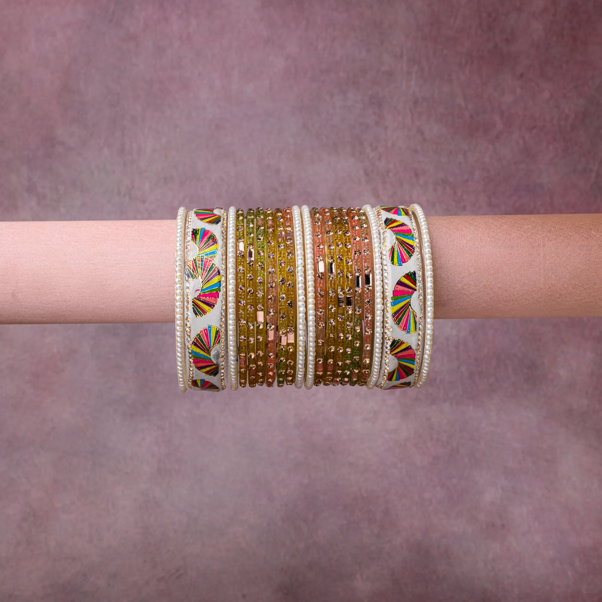 A grounding Ivory forms the heart of the set, while touches of Magenta, Scarlet, Marigold, Lime Green, Teal, Royal Blue, Metallic Gold, Champagne Crystal, Pearl White add charm.

A thoughtful composition of Lacquer, Glass, Faux Pearls, Crystal Rhinestones, Gold-Toned Metal, designed to feel complete without being heavy.
Each element layers seamlessly, creating a look that is refined, wearable and quietly striking.