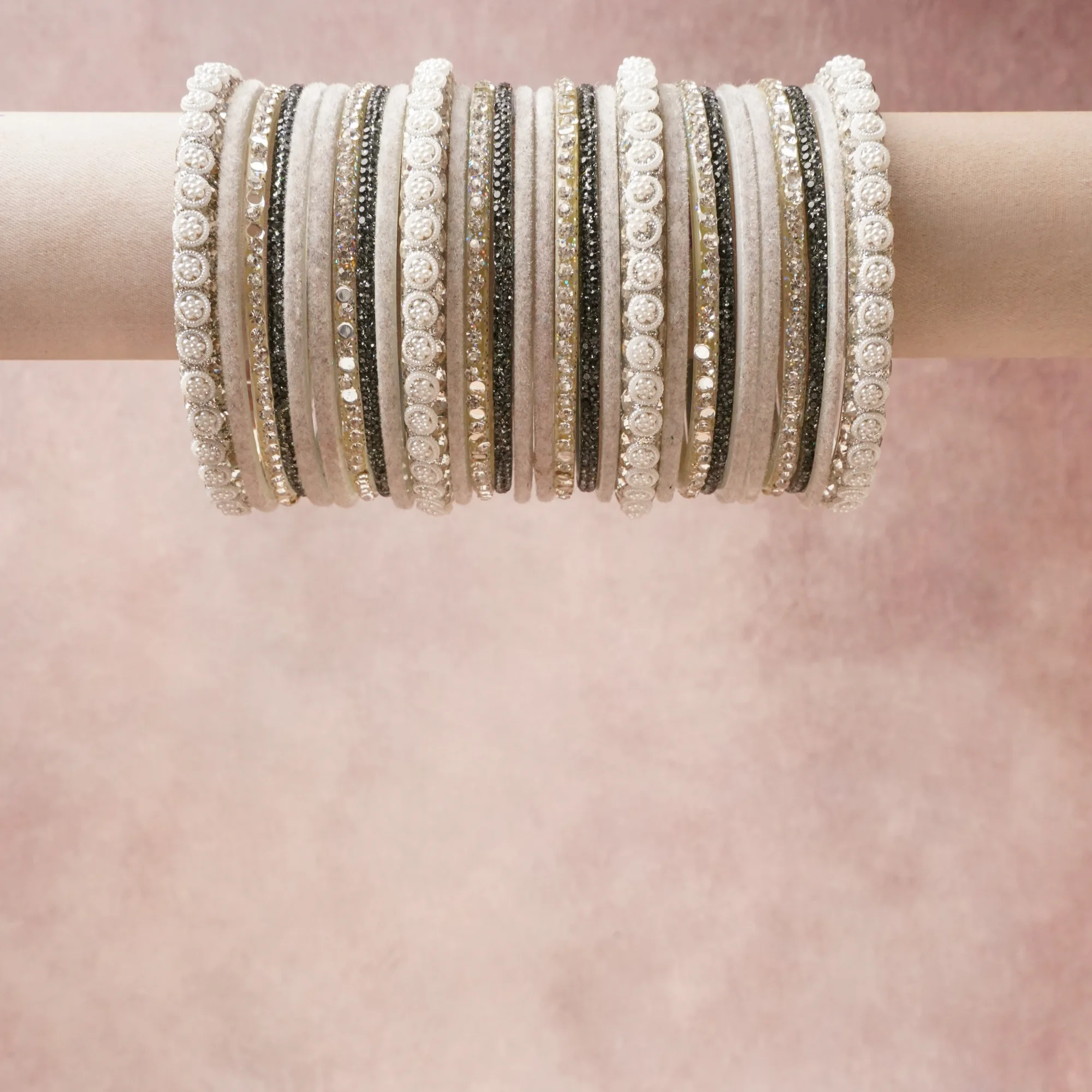 A grounding Grey forms the heart of the set, while touches of Silver add charm.

A thoughtful composition of Textile, Crystals, Pearls, Metal, designed to feel complete without being heavy.
Each element layers seamlessly, creating a look that is refined, wearable and quietly striking.
