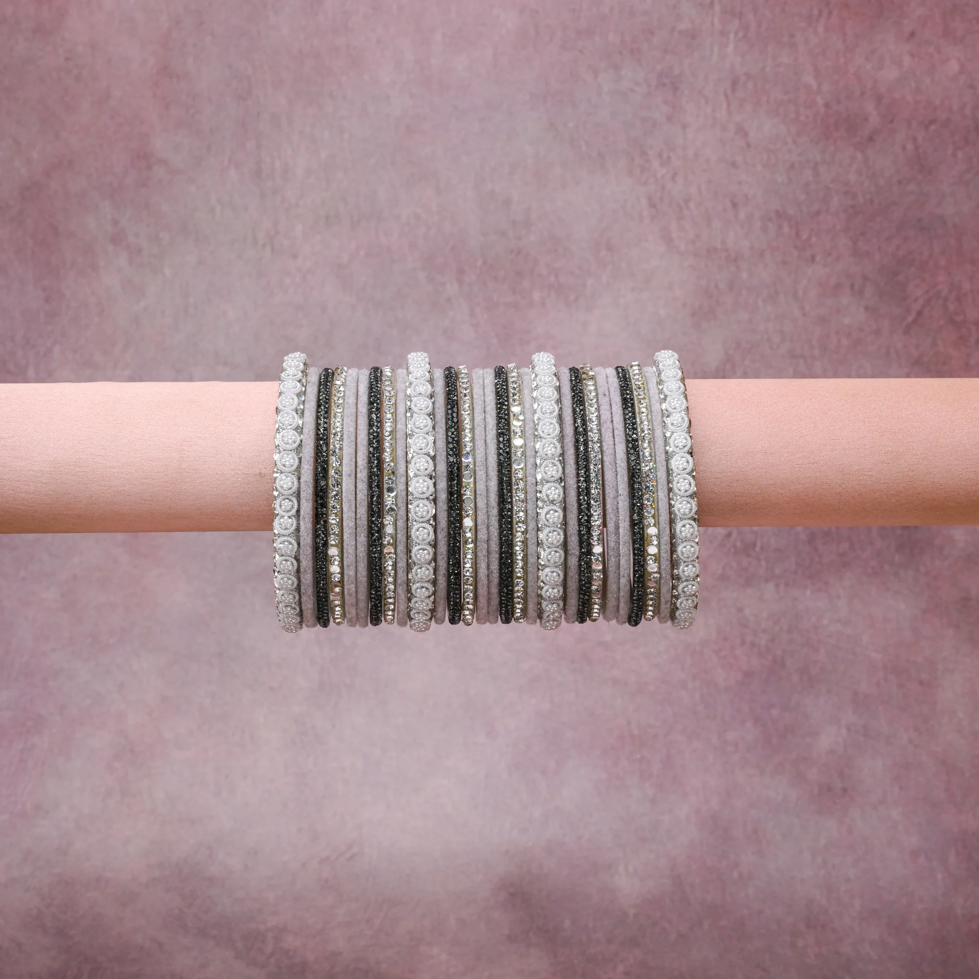 A grounding Grey forms the heart of the set, while touches of Silver add charm.

A thoughtful composition of Textile, Crystals, Pearls, Metal, designed to feel complete without being heavy.
Each element layers seamlessly, creating a look that is refined, wearable and quietly striking.