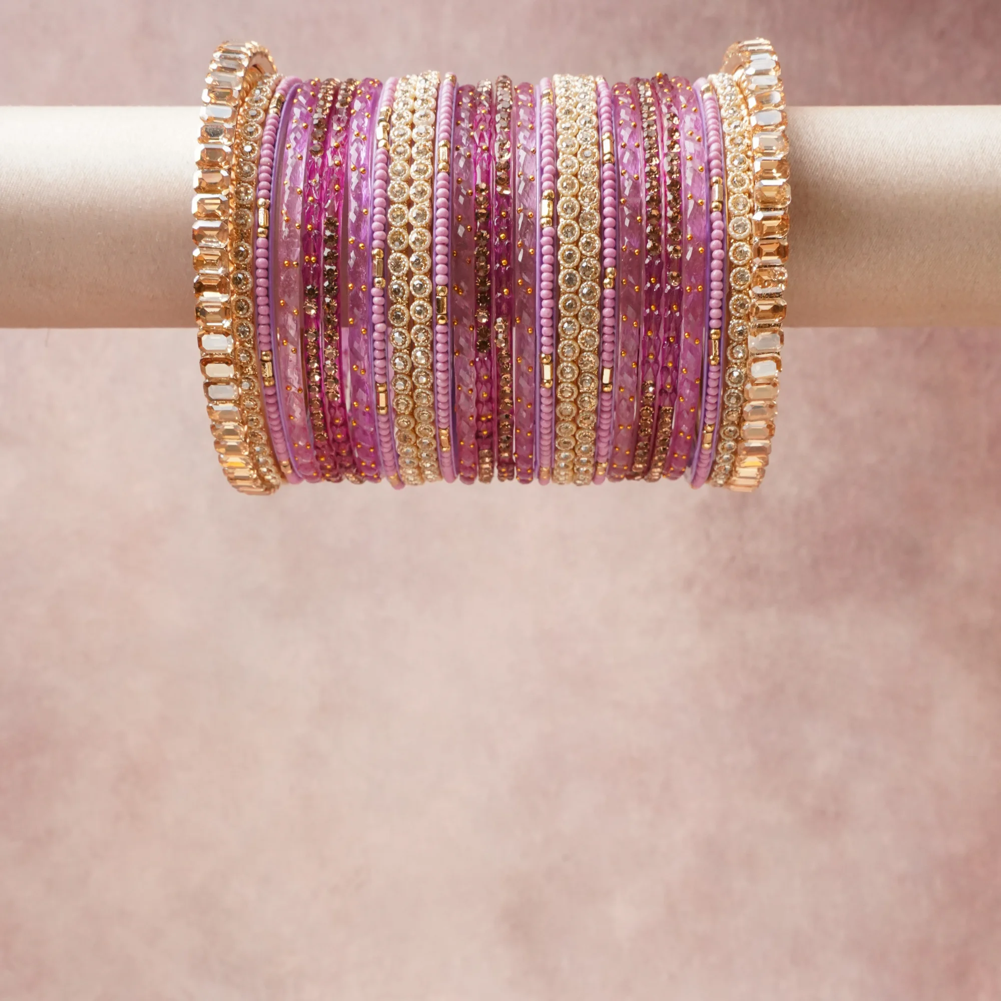 A grounding Lavender forms the heart of the set, while touches of Blush Pink, Clear Crystal add charm.

A thoughtful composition of Gold-toned Metal, Glass, Crystal, Beads, designed to feel complete without being heavy.
Each element layers seamlessly, creating a look that is refined, wearable and quietly striking.