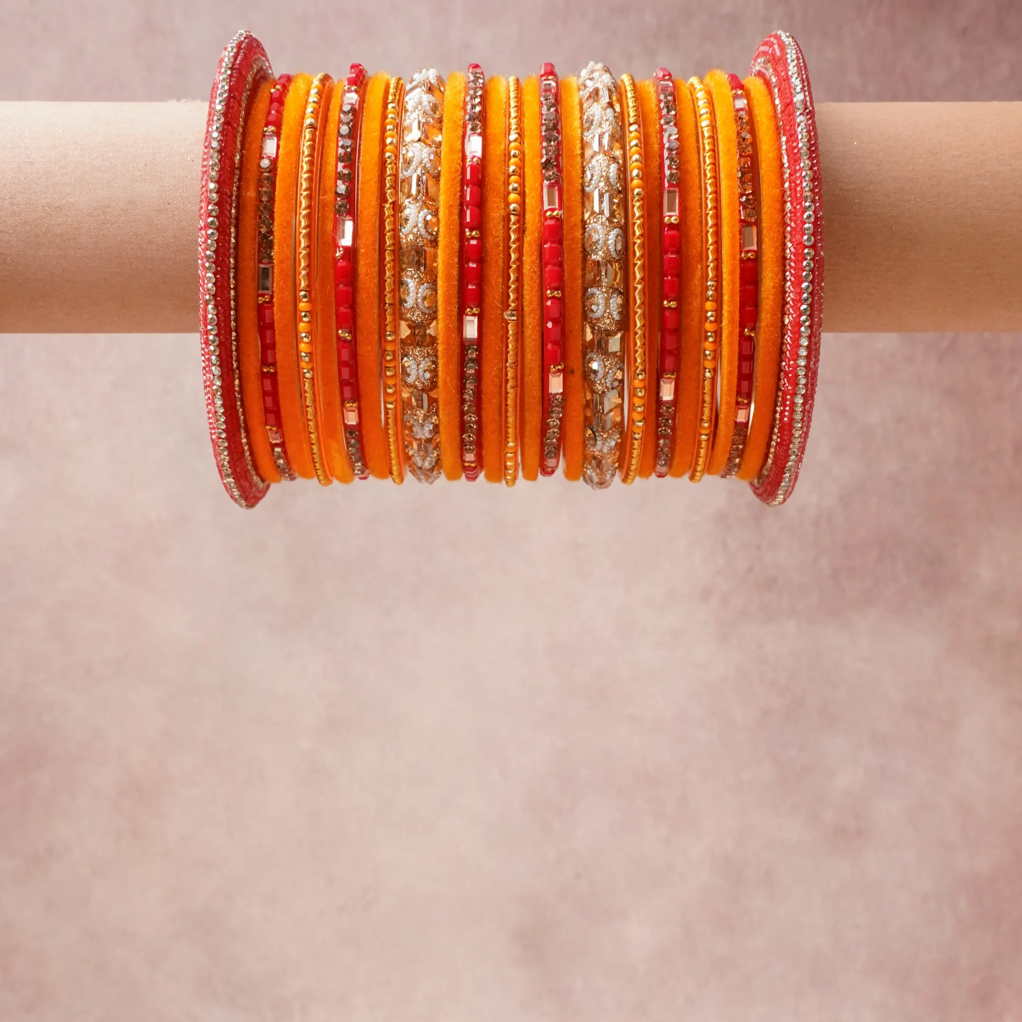 A grounding Saffron Orange forms the heart of the set, while touches of Gold, Ivory add charm.

A thoughtful composition of Velvet Textile, Glass, Rhinestones, Mirror Work, Seed Beads, Gold-toned Metal, designed to feel complete without being heavy.
Each element layers seamlessly, creating a look that is refined, wearable and quietly striking.