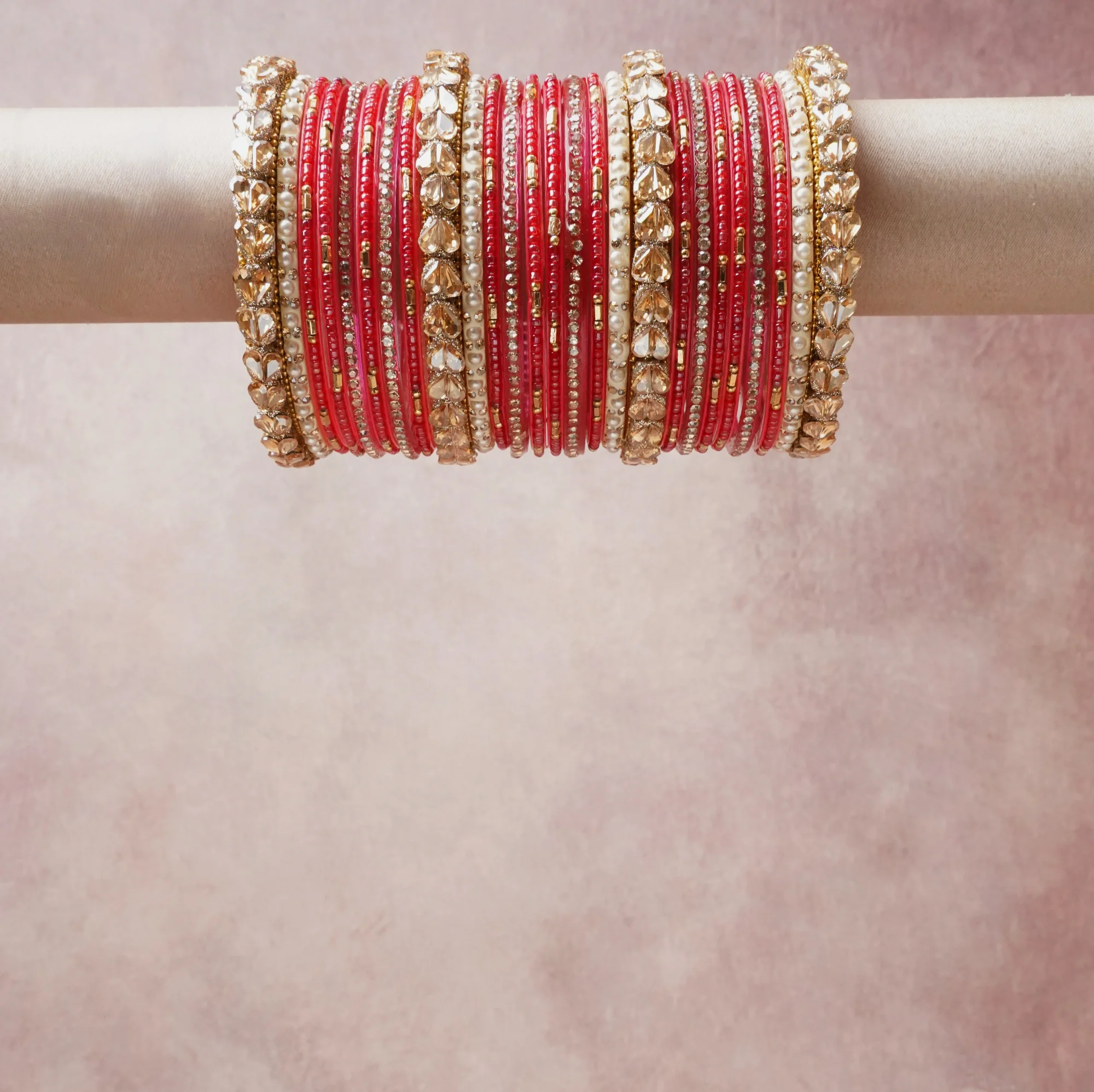 A grounding ruby red forms the heart of the set, while touches of gold, pearl white add charm.

A thoughtful composition of glass bangles, crystal stones, metal embellishments, designed to feel complete without being heavy.
Each element layers seamlessly, creating a look that is refined, wearable and quietly striking.