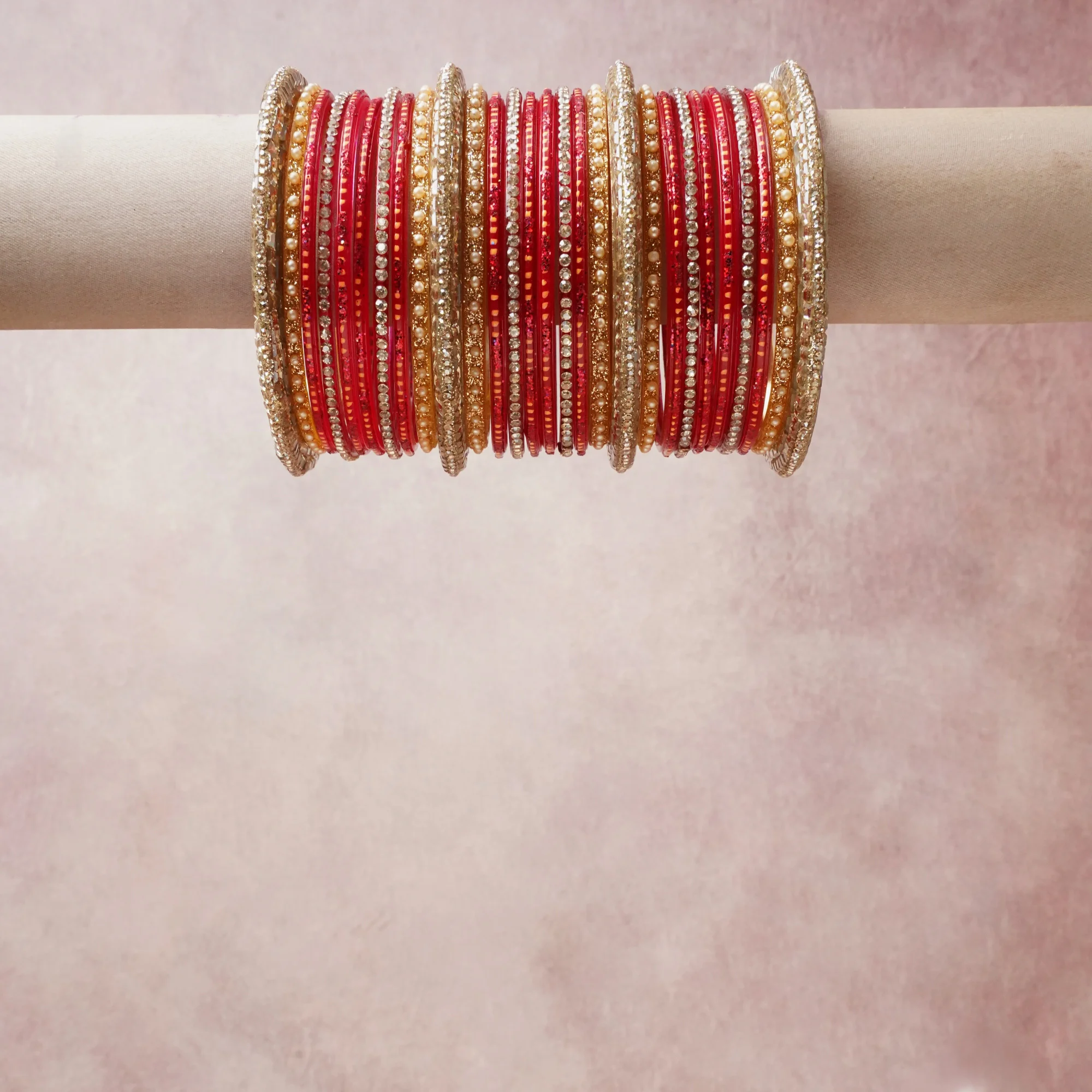 A grounding red forms the heart of the set, while touches of gold, white, champagne add charm.

A thoughtful composition of glass bangles, rhinestones, metal, designed to feel complete without being heavy.
Each element layers seamlessly, creating a look that is refined, wearable and quietly striking.