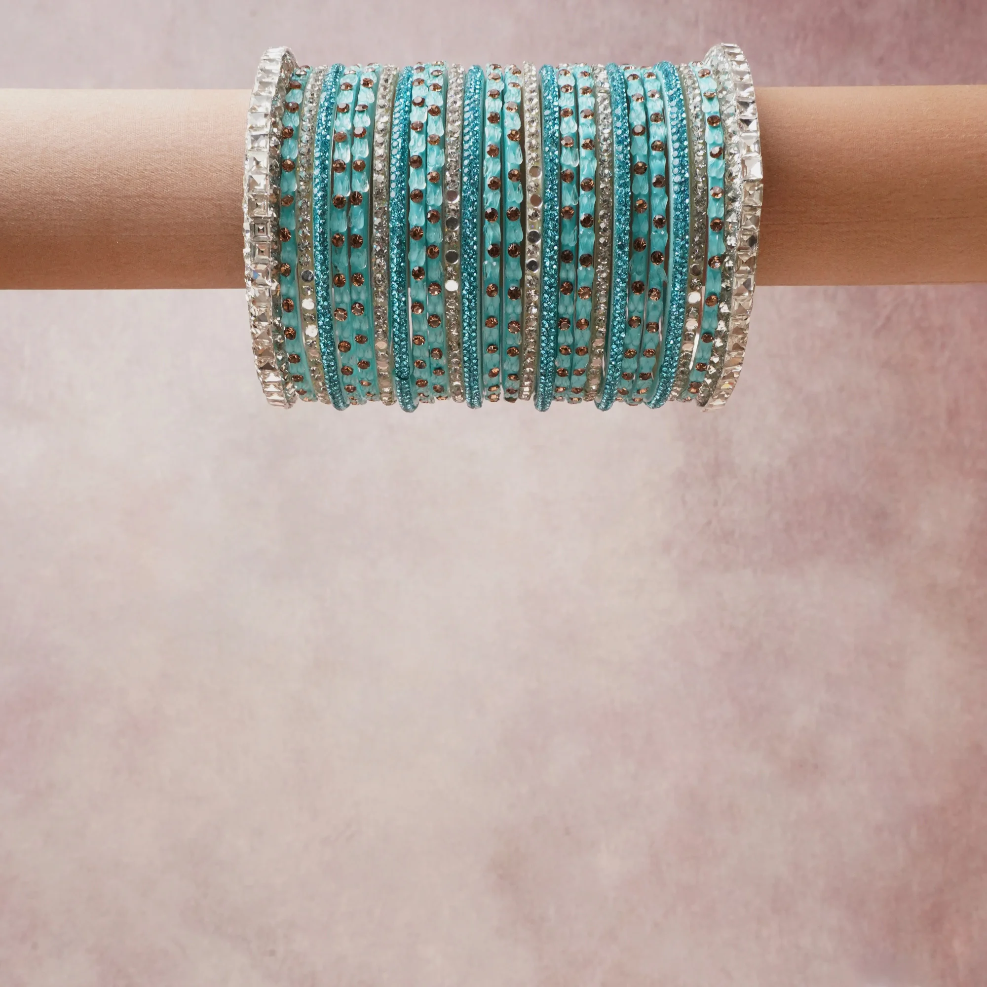 A grounding turquoise forms the heart of the set, while touches of silver, clear crystal add charm.

A thoughtful composition of glass bangles, rhinestones, metallic alloy, designed to feel complete without being heavy.
Each element layers seamlessly, creating a look that is refined, wearable and quietly striking.