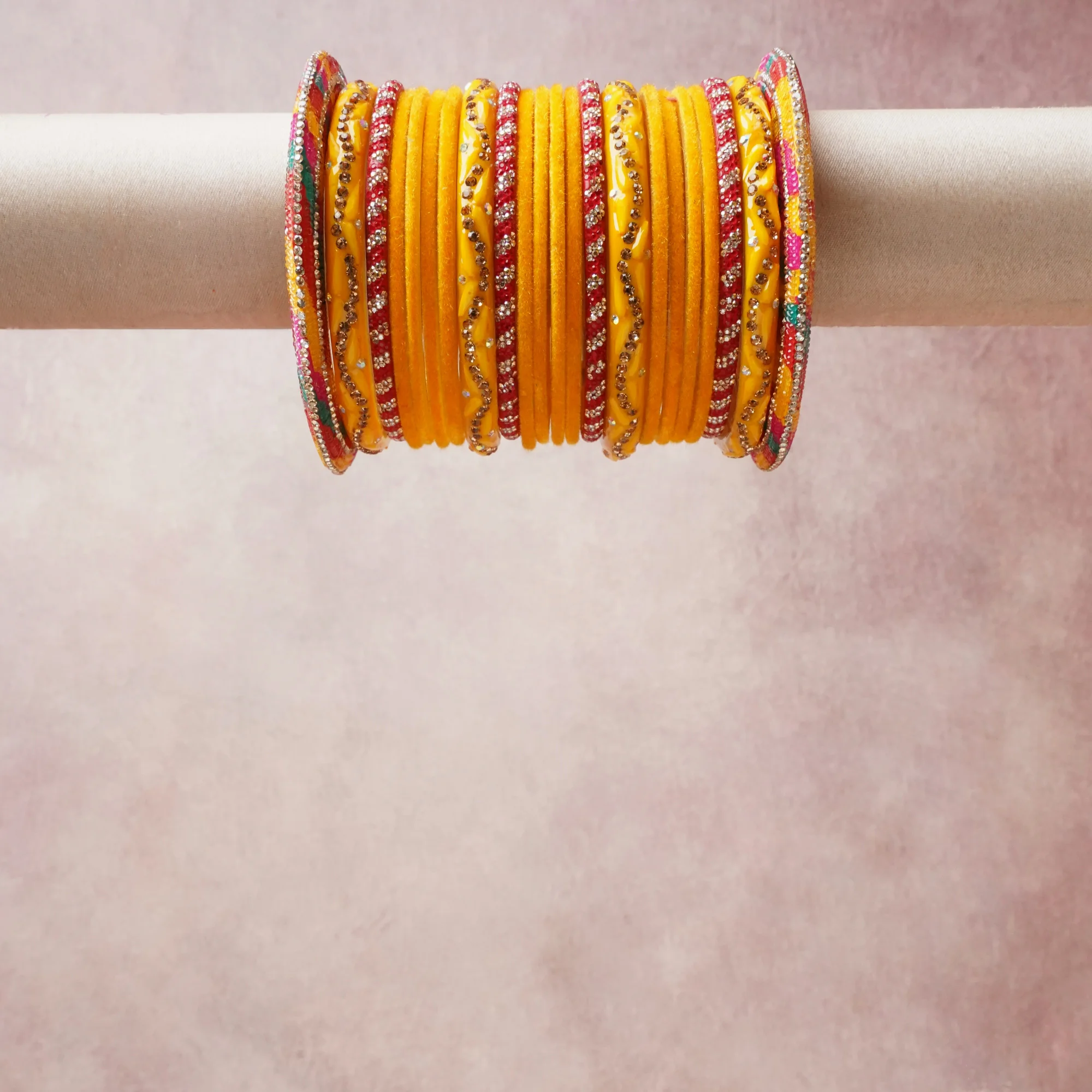 A grounding saffron yellow forms the heart of the set, while touches of red add charm.

A thoughtful composition of glass bangles with rhinestone embellishments, designed to feel complete without being heavy.
Each element layers seamlessly, creating a look that is refined, wearable and quietly striking.