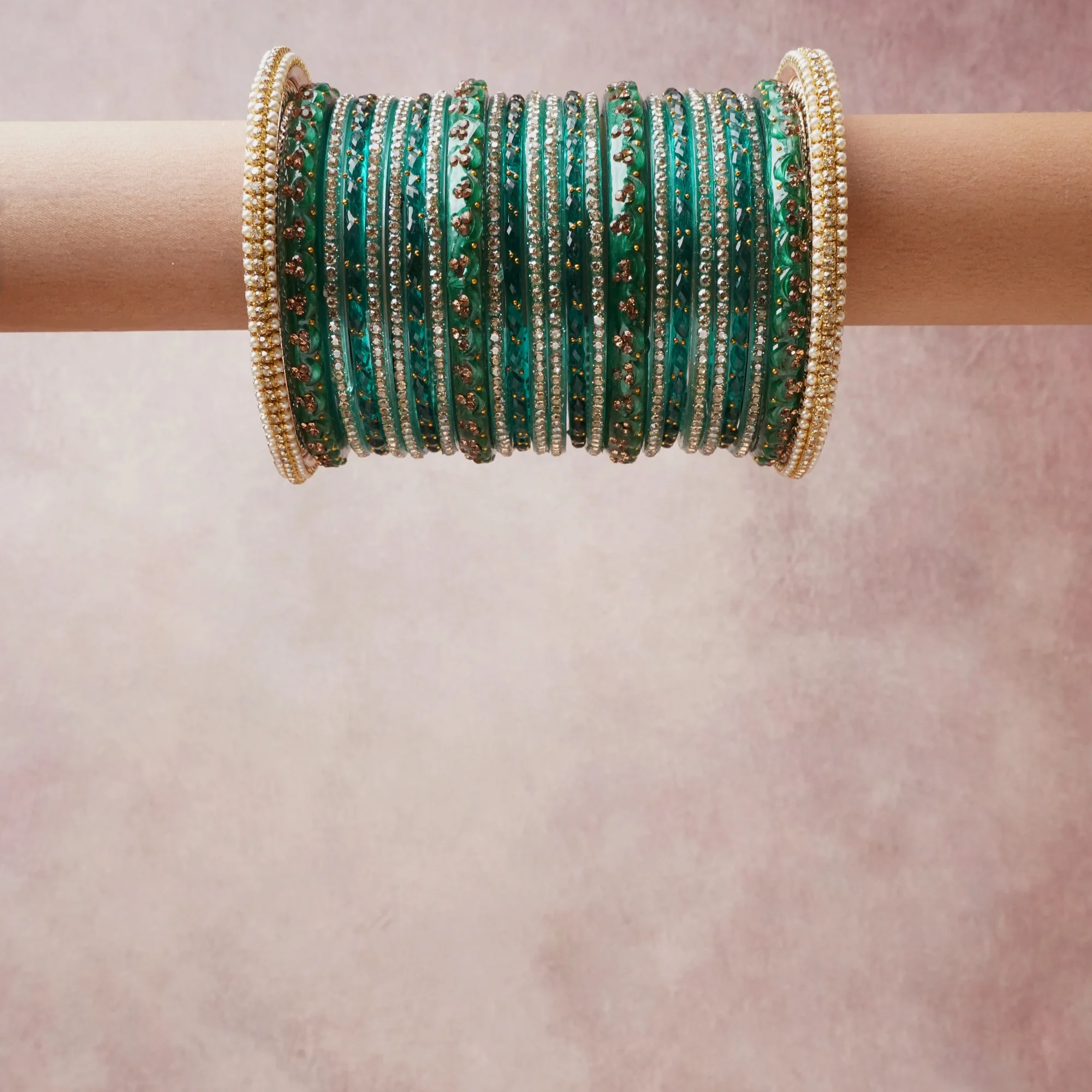 A grounding Emerald Green forms the heart of the set, while touches of  add charm.

A thoughtful composition of Glass Bangle, Rhinestone, Metal Alloy, designed to feel complete without being heavy.
Each element layers seamlessly, creating a look that is refined, wearable and quietly striking.