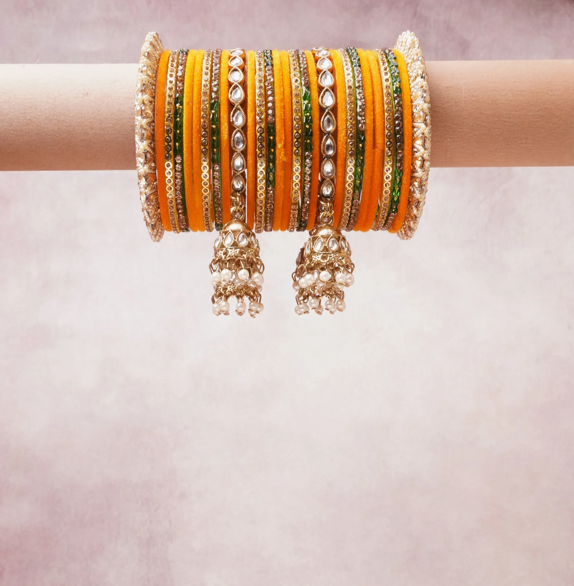 A majestic saffron orange set, complemented by gold, ivory, green featuring silk thread, gold-tone metal, kundan stones, pearl beads.
Rich, ceremonial, and designed to be passed through generations.
