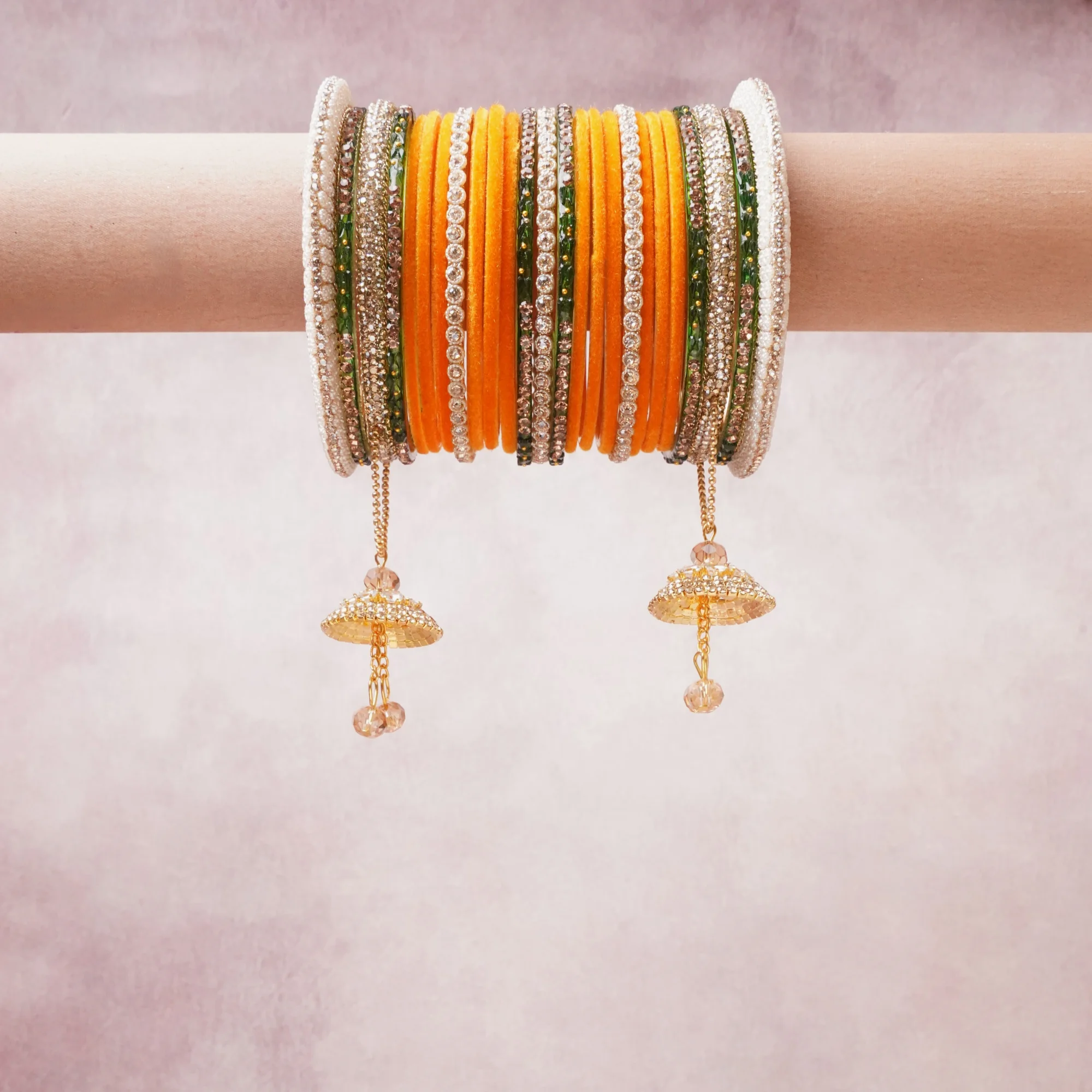 A commanding Orange anchors this beautiful set, enriched with accents of Green, Gold, White that add depth and dimension.

Featuring a striking composition of glass bangles, rhinestone, metal, this set carries intricate craftsmanship and strong presence. Grand in form, it is created for moments that deserve to be marked.