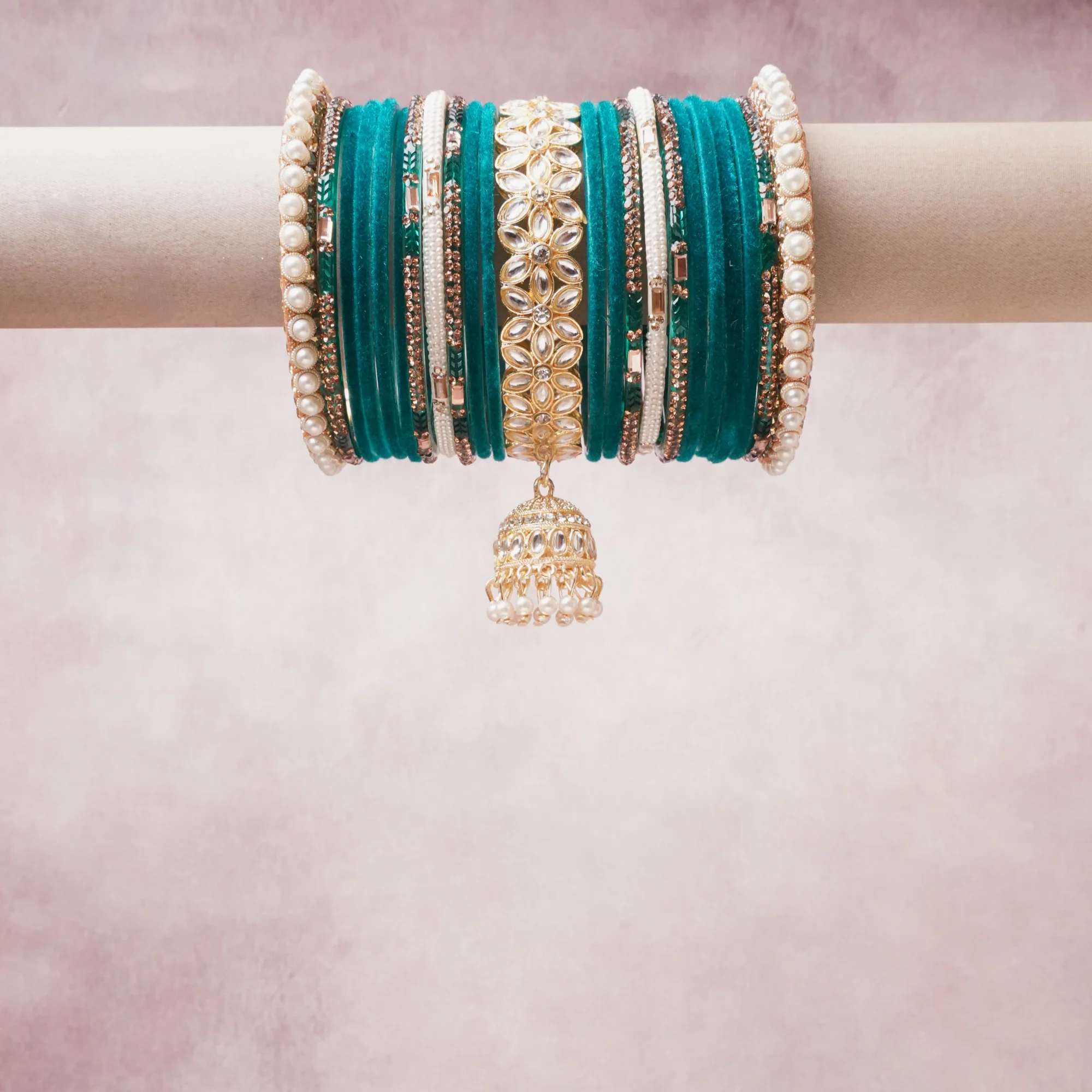 A commanding Turquoise anchors this beautiful set, enriched with accents of Gold, Pearl, White that add depth and dimension.

Featuring a striking composition of glass bangles, faux pearls, gold-tone metal, this set carries intricate craftsmanship and strong presence. Grand in form, it is created for moments that deserve to be marked.
