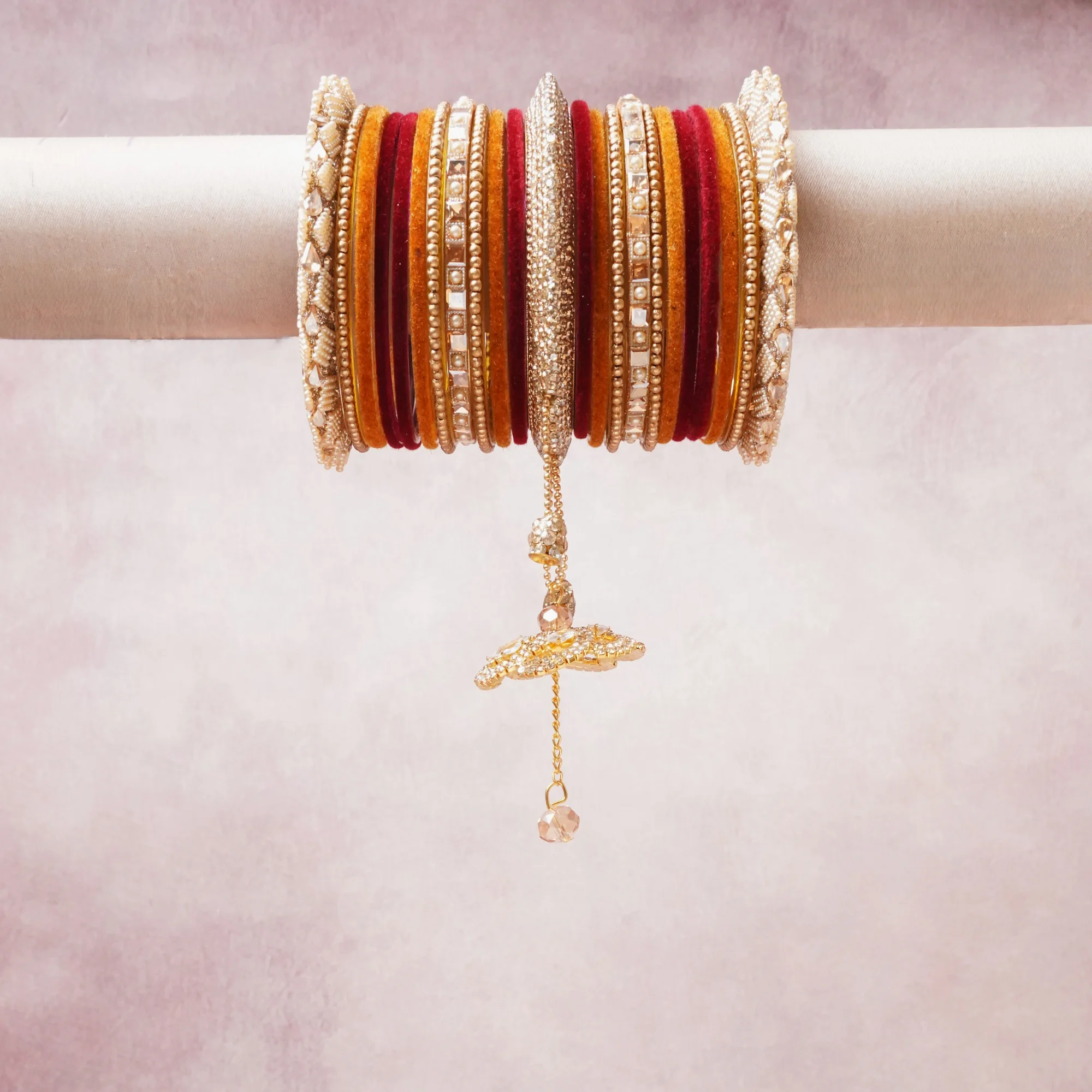 A commanding Champagne Gold anchors this beautiful set, enriched with accents of Ruby Red, Pearl White, Burnt Orange that add depth and dimension.

Featuring a striking composition of gold-plated metal, glass stones, crystal beads, this set carries intricate craftsmanship and strong presence. Grand in form, it is created for moments that deserve to be marked.