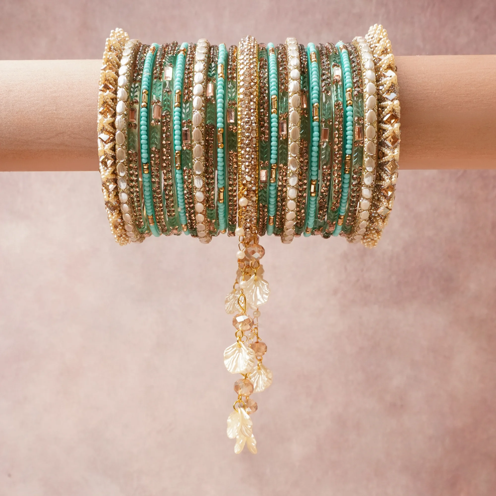 A commanding Teal anchors this beautiful set, enriched with accents of Pearl White, Champagne, Blush Pink that add depth and dimension.

Featuring a striking composition of Glass, Gold-toned Metal Alloy, Simulated Pearls, Faceted Crystal, Shell, this set carries intricate craftsmanship and strong presence. Grand in form, it is created for moments that deserve to be marked.
