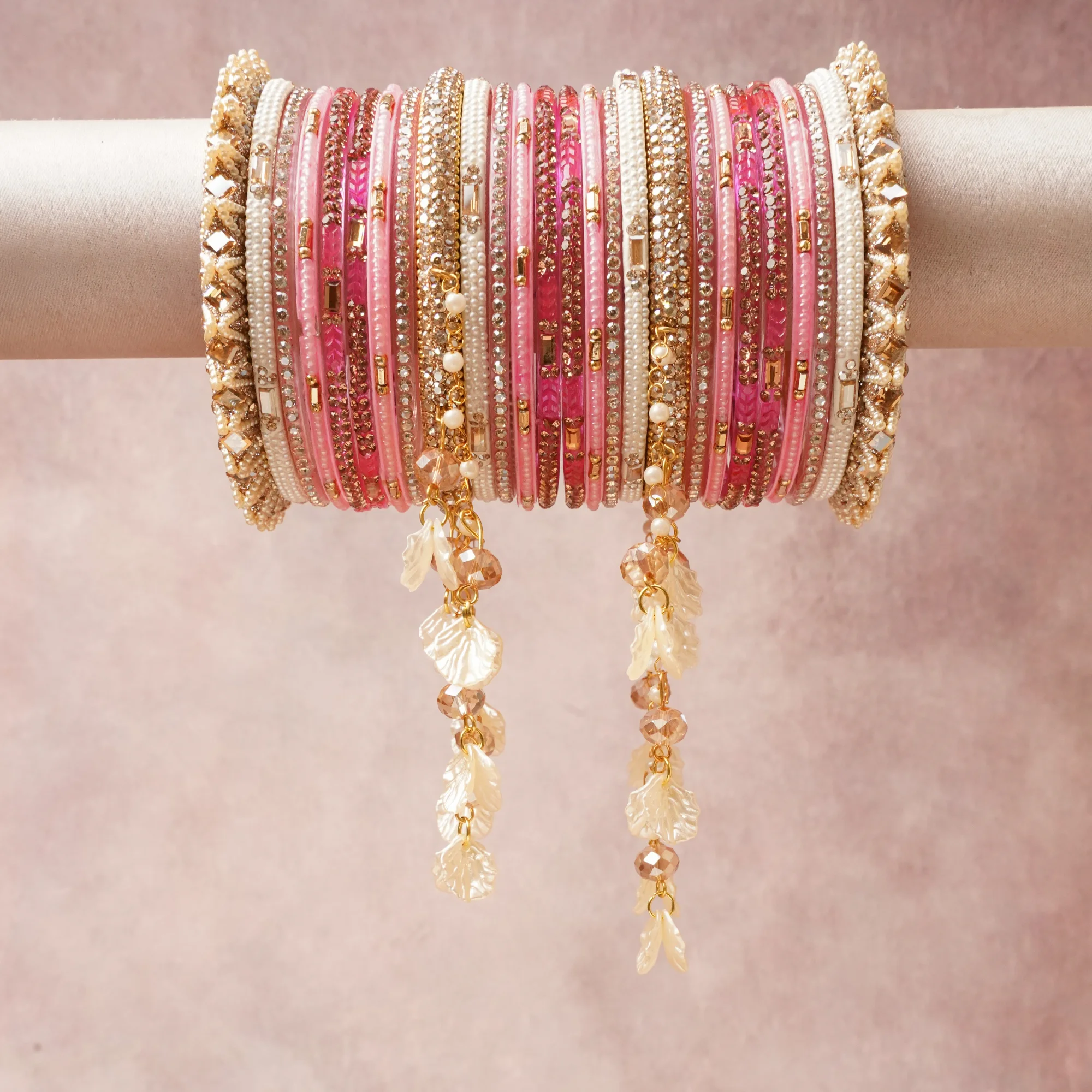 A commanding Rose Pink anchors this beautiful set, enriched with accents of Gold, Clear (Diamond Simulant), Champagne that add depth and dimension.

Featuring a striking composition of Glass (Bangles, Faceted Beads), Gold-toned Alloy (Metalwork, Chains), Rhinestones, Simulated Pearls, Mother-of-Pearl (Dangles), this set carries intricate craftsmanship and strong presence. Grand in form, it is created for moments that deserve to be marked.