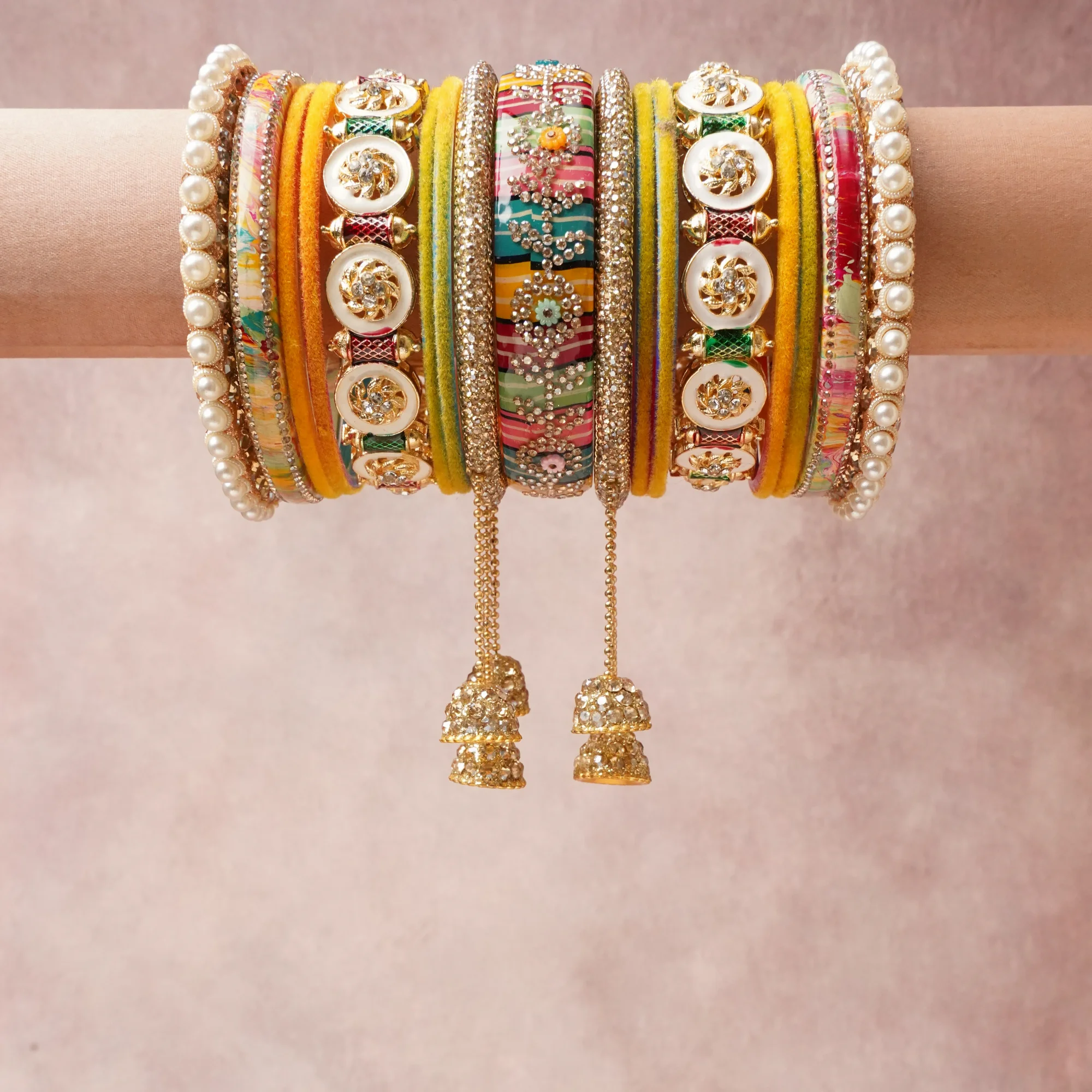 A commanding Vibrant Yellow anchors this beautiful set, enriched with accents of Forest Green, Maroon, White, Soft Pink, Teal, Gold that add depth and dimension.

Featuring a striking composition of Silk Fabric, Gold-toned Metal, Faux Pearls, Cubic Zirconia, Enamel, Glitter, this set carries intricate craftsmanship and strong presence. Grand in form, it is created for moments that deserve to be marked.
