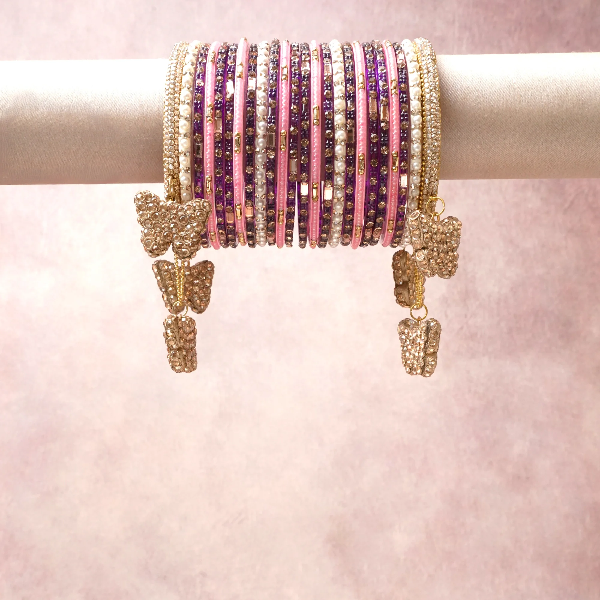 A commanding pink anchors this beautiful set, enriched with accents of purple, gold, ivory that add depth and dimension.

Featuring a striking composition of crystal, faux pearl, gold-tone metal, this set carries intricate craftsmanship and strong presence. Grand in form, it is created for moments that deserve to be marked.