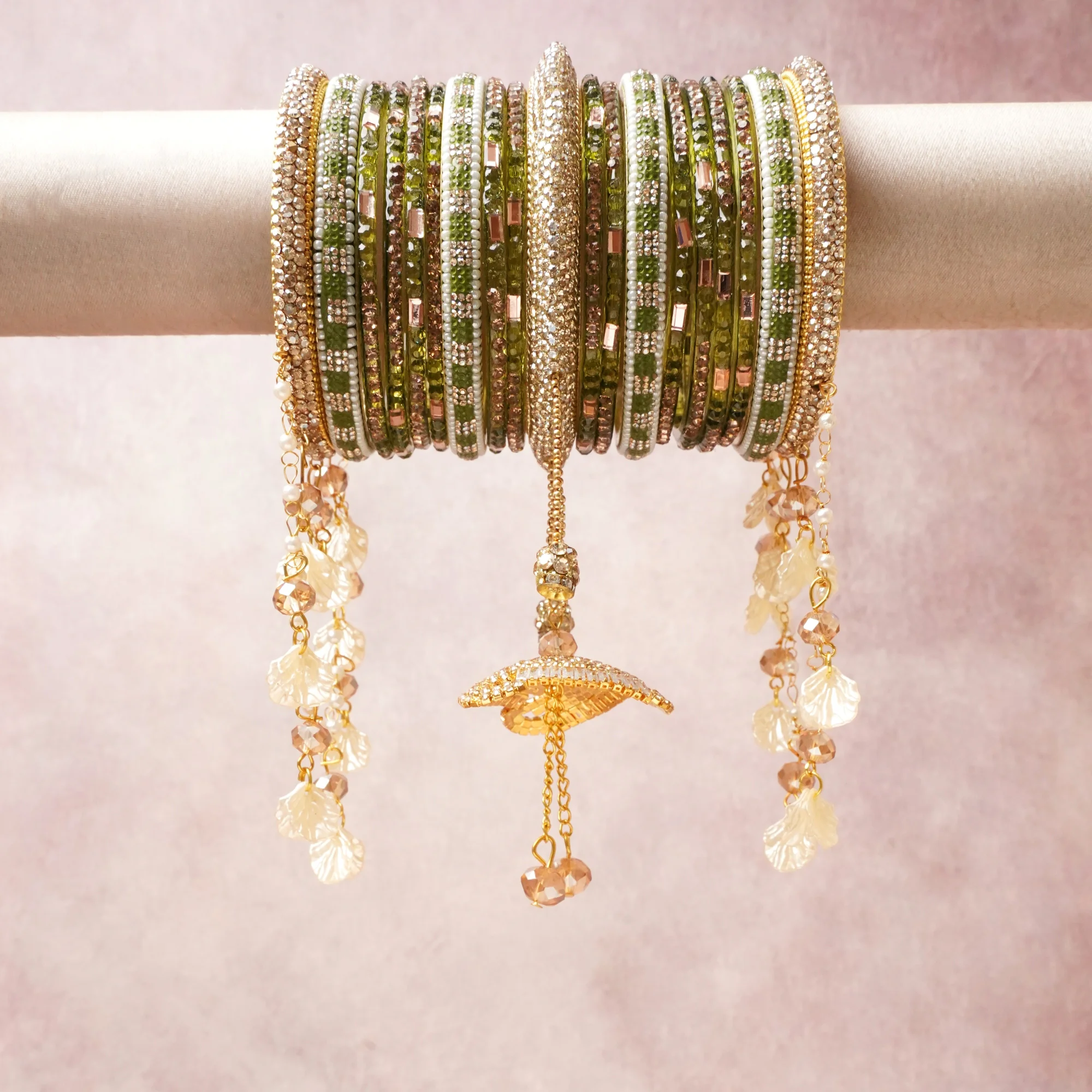 A commanding olive green anchors this beautiful set, enriched with accents of gold, champagne, ivory that add depth and dimension.

Featuring a striking composition of crystal beads, metal, shell charms, this set carries intricate craftsmanship and strong presence. Grand in form, it is created for moments that deserve to be marked.