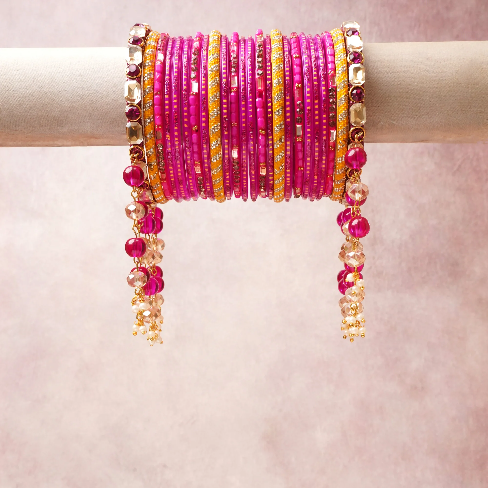 A commanding Fuchsia Pink anchors this beautiful set, enriched with accents of Gold, Magenta that add depth and dimension.

Featuring a striking composition of Glass Bangles, Rhinestone, Gold-tone Alloy, this set carries intricate craftsmanship and strong presence. Grand in form, it is created for moments that deserve to be marked.