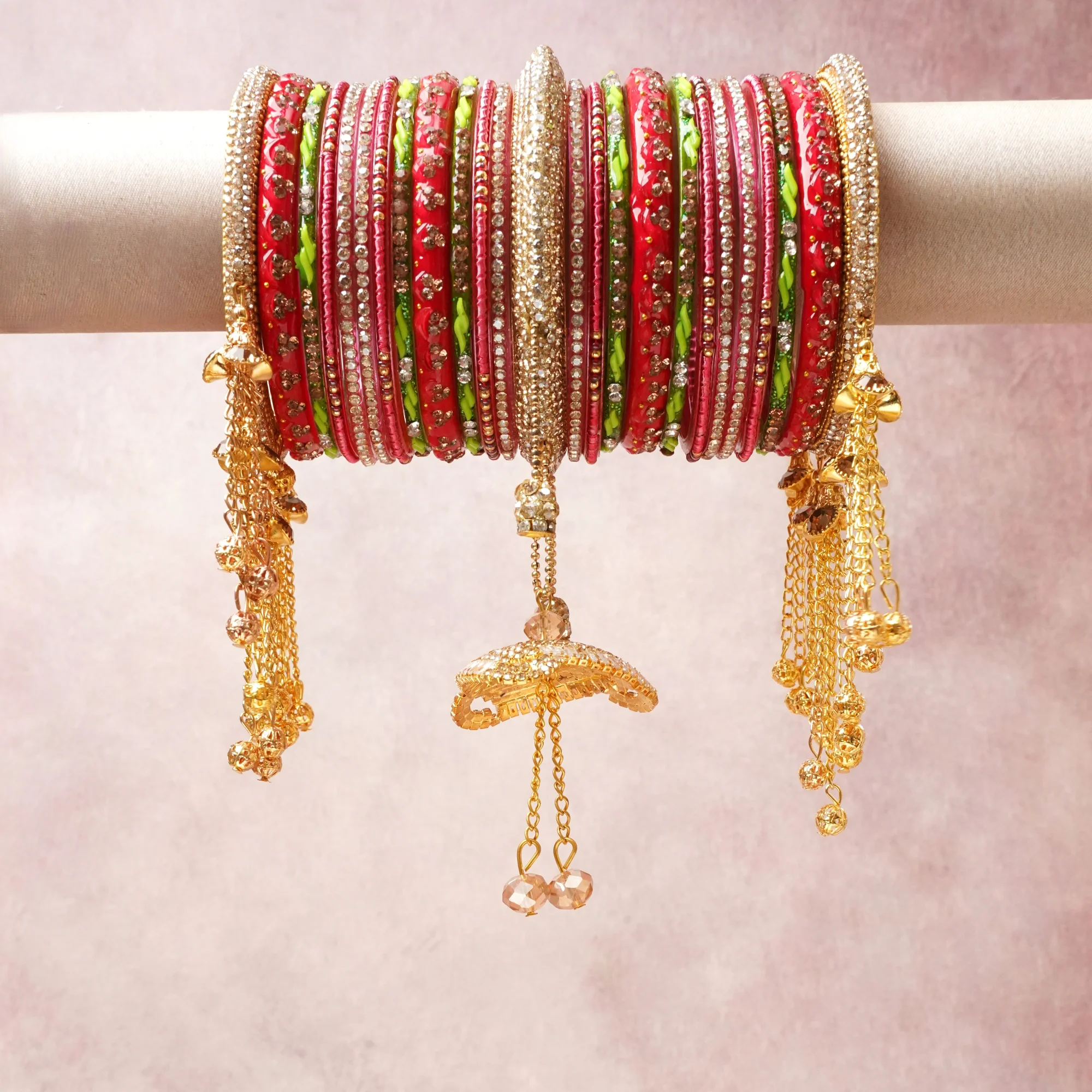 A commanding red anchors this beautiful set, enriched with accents of gold, pink, lime green that add depth and dimension.

Featuring a striking composition of glass bangles, rhinestones, gold-tone metal, this set carries intricate craftsmanship and strong presence. Grand in form, it is created for moments that deserve to be marked.