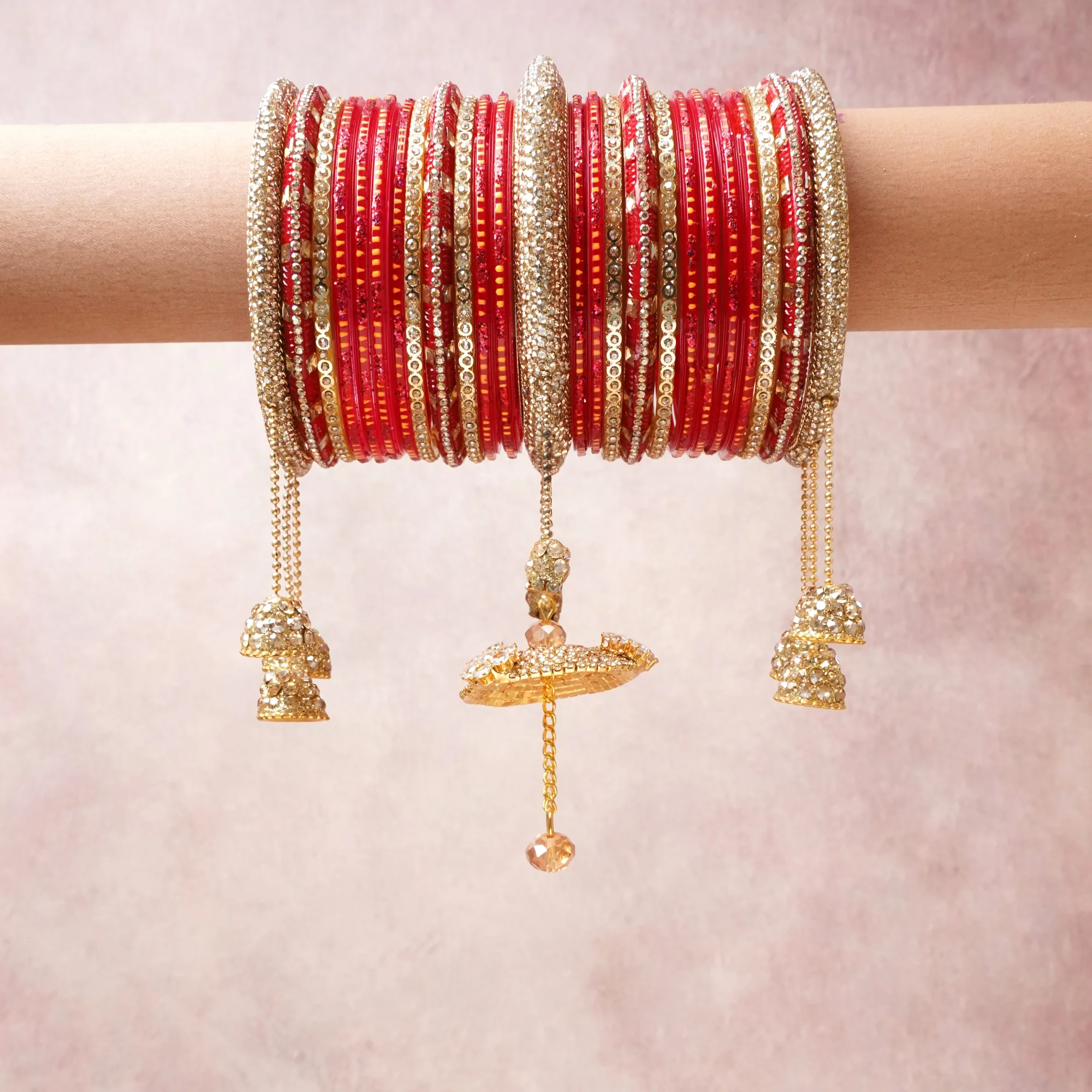 A commanding red anchors this beautiful set, enriched with accents of gold, champagne that add depth and dimension.

Featuring a striking composition of glass bangles, rhinestone, gold-toned metal, this set carries intricate craftsmanship and strong presence. Grand in form, it is created for moments that deserve to be marked.