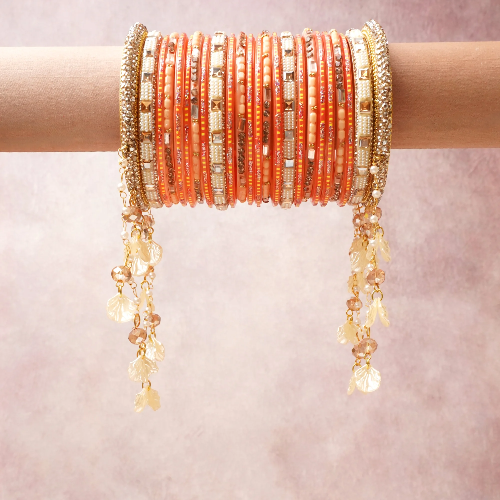 A commanding Coral Orange anchors this beautiful set, enriched with accents of Gold, Ivory, Peach that add depth and dimension.

Featuring a striking composition of Beaded Metal Bangle Bracelet, this set carries intricate craftsmanship and strong presence. Grand in form, it is created for moments that deserve to be marked.