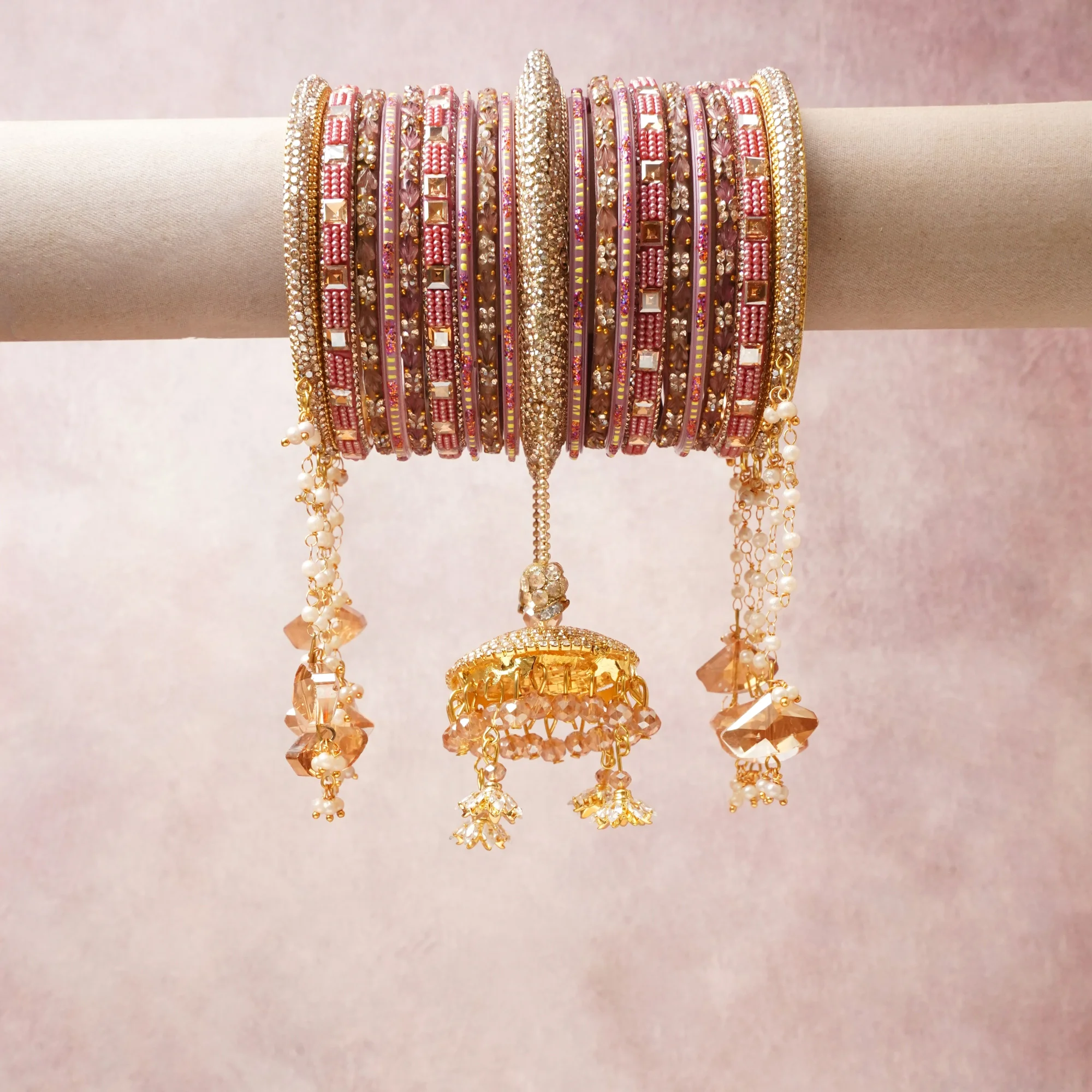 A commanding blush pink anchors this beautiful set, enriched with accents of gold, champagne, ivory that add depth and dimension.

Featuring a striking composition of kundan, beads, crystals, this set carries intricate craftsmanship and strong presence. Grand in form, it is created for moments that deserve to be marked.