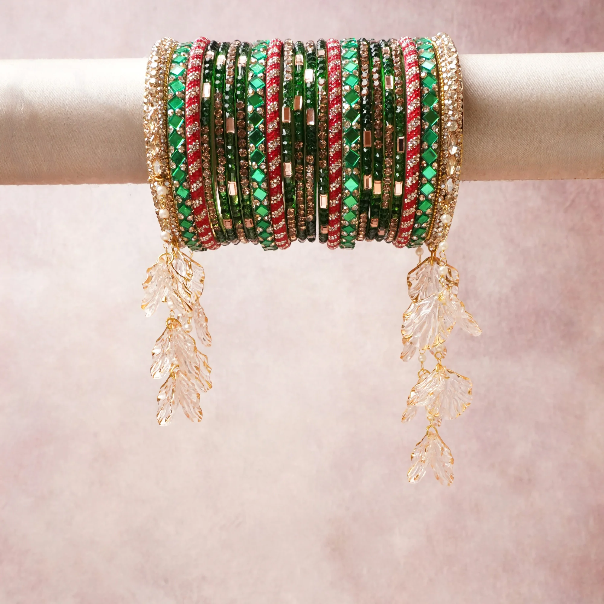 A commanding emerald green anchors this beautiful set, enriched with accents of gold, ruby red, clear crystal that add depth and dimension.

Featuring a striking composition of glass bangles, gold-tone metal, faux pearls, crystal leaf charms, this set carries intricate craftsmanship and strong presence. Grand in form, it is created for moments that deserve to be marked.
