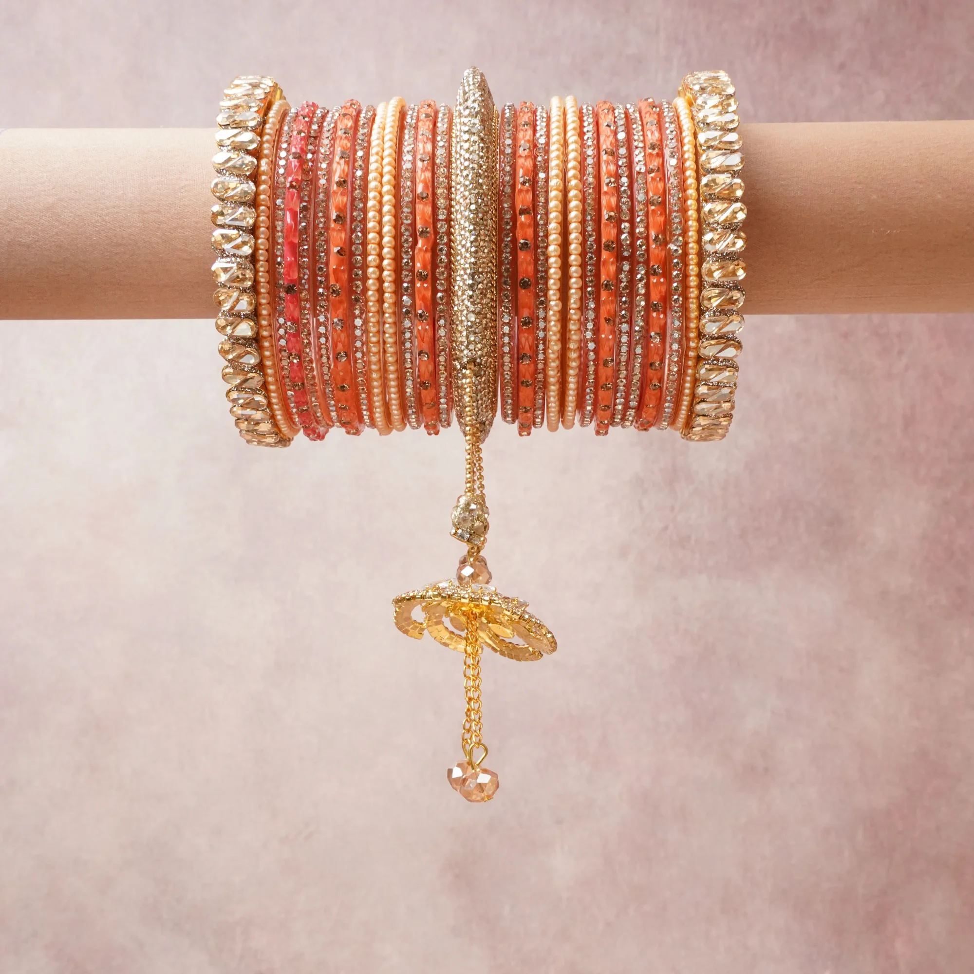 A commanding coral orange anchors this beautiful set, enriched with accents of gold, champagne, ivory that add depth and dimension.

Featuring a striking composition of kundan, pearl beads, rhinestone, this set carries intricate craftsmanship and strong presence. Grand in form, it is created for moments that deserve to be marked.
