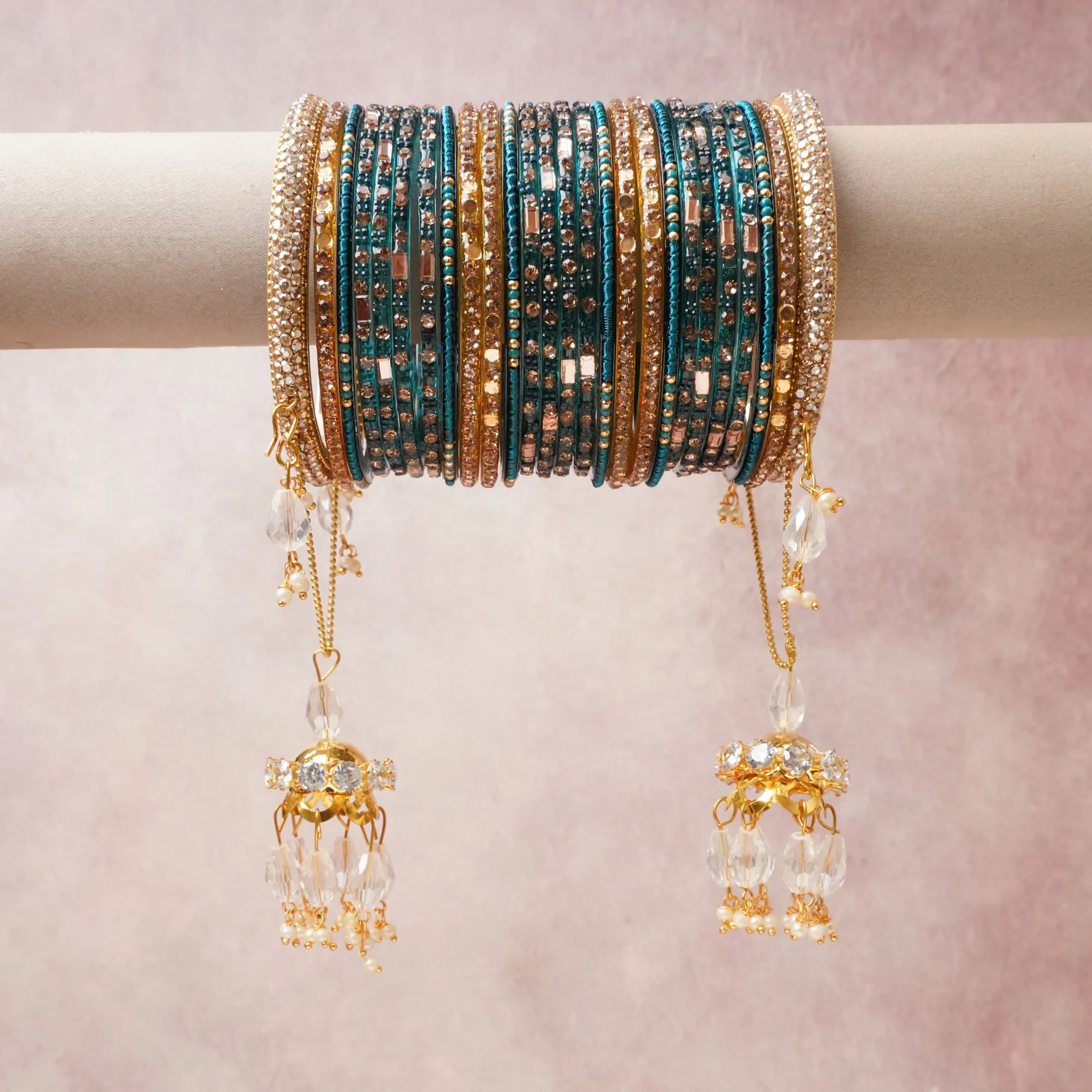 A commanding teal anchors this beautiful set, enriched with accents of gold, clear crystal, rose gold that add depth and dimension.

Featuring a striking composition of glass beads, rhinestones, gold-tone metal, crystal drops, this set carries intricate craftsmanship and strong presence. Grand in form, it is created for moments that deserve to be marked.