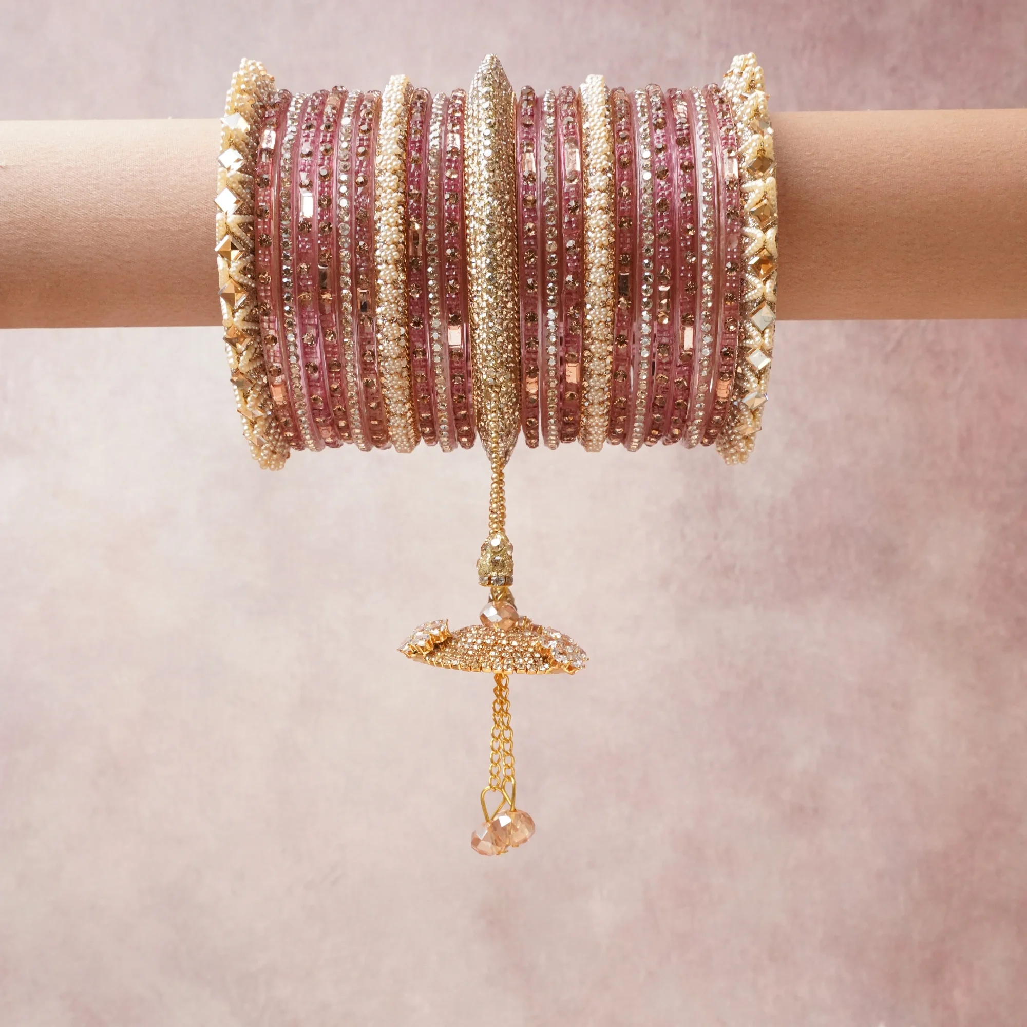 A commanding blush pink anchors this beautiful set, enriched with accents of gold, champagne, ivory that add depth and dimension.

Featuring a striking composition of glass beads, rhinestones, metal, this set carries intricate craftsmanship and strong presence. Grand in form, it is created for moments that deserve to be marked.