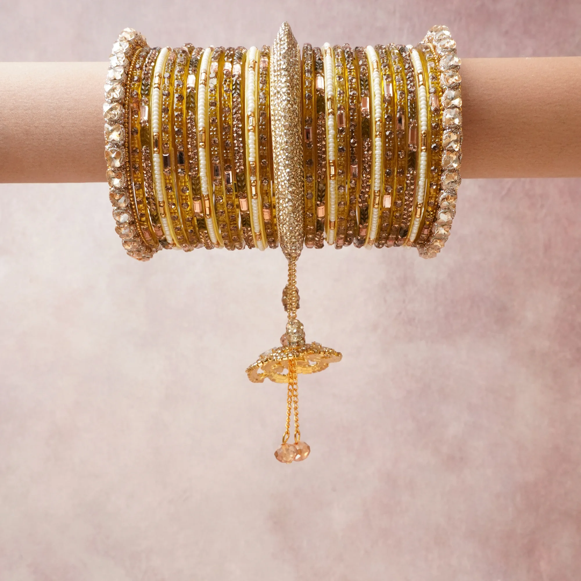 A commanding gold anchors this beautiful set, enriched with accents of ivory, champagne, rose gold that add depth and dimension.

Featuring a striking composition of metal, rhinestone, crystal, beadwork, this set carries intricate craftsmanship and strong presence. Grand in form, it is created for moments that deserve to be marked.