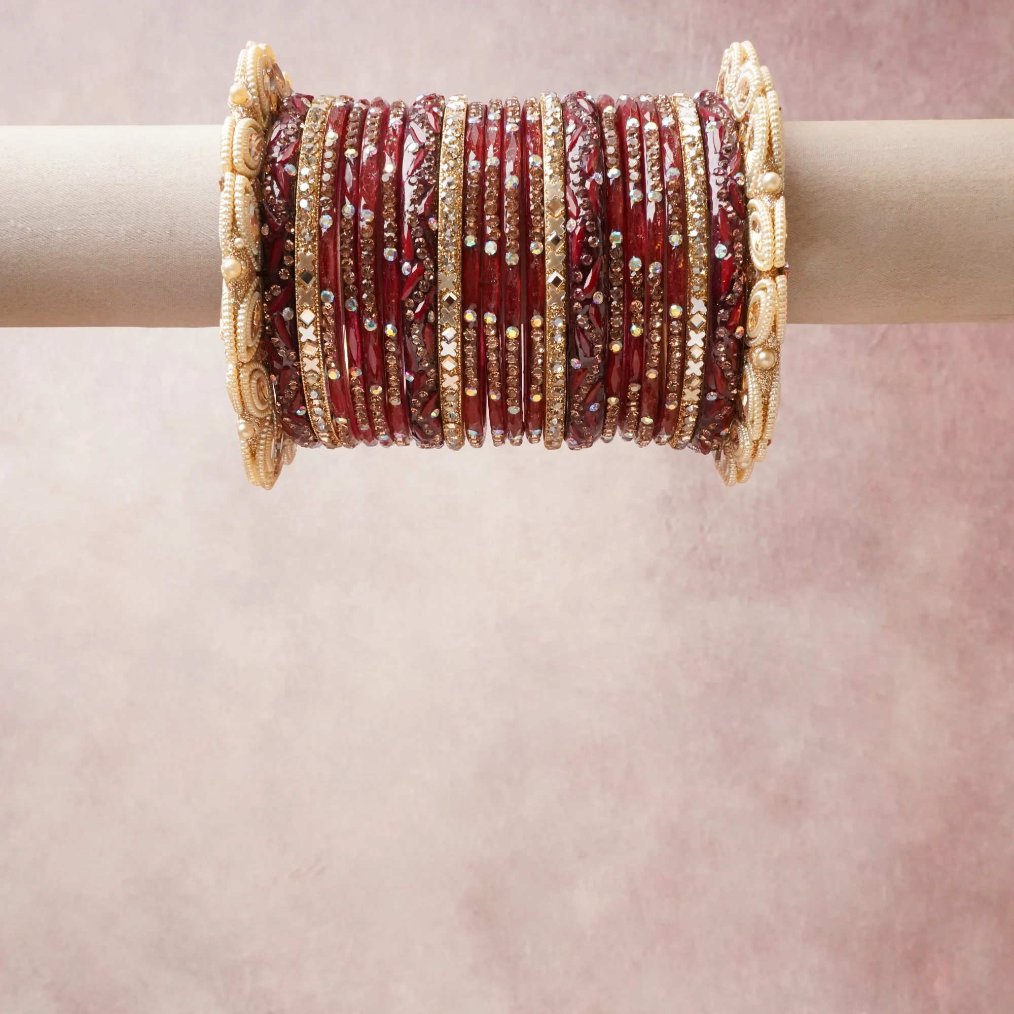 A commanding deep red anchors this beautiful set, enriched with accents of gold, ivory, rose gold that add depth and dimension.

Featuring a striking composition of glass bangles, rhinestone crystals, faux pearl embellishments, this set carries intricate craftsmanship and strong presence. Grand in form, it is created for moments that deserve to be marked.