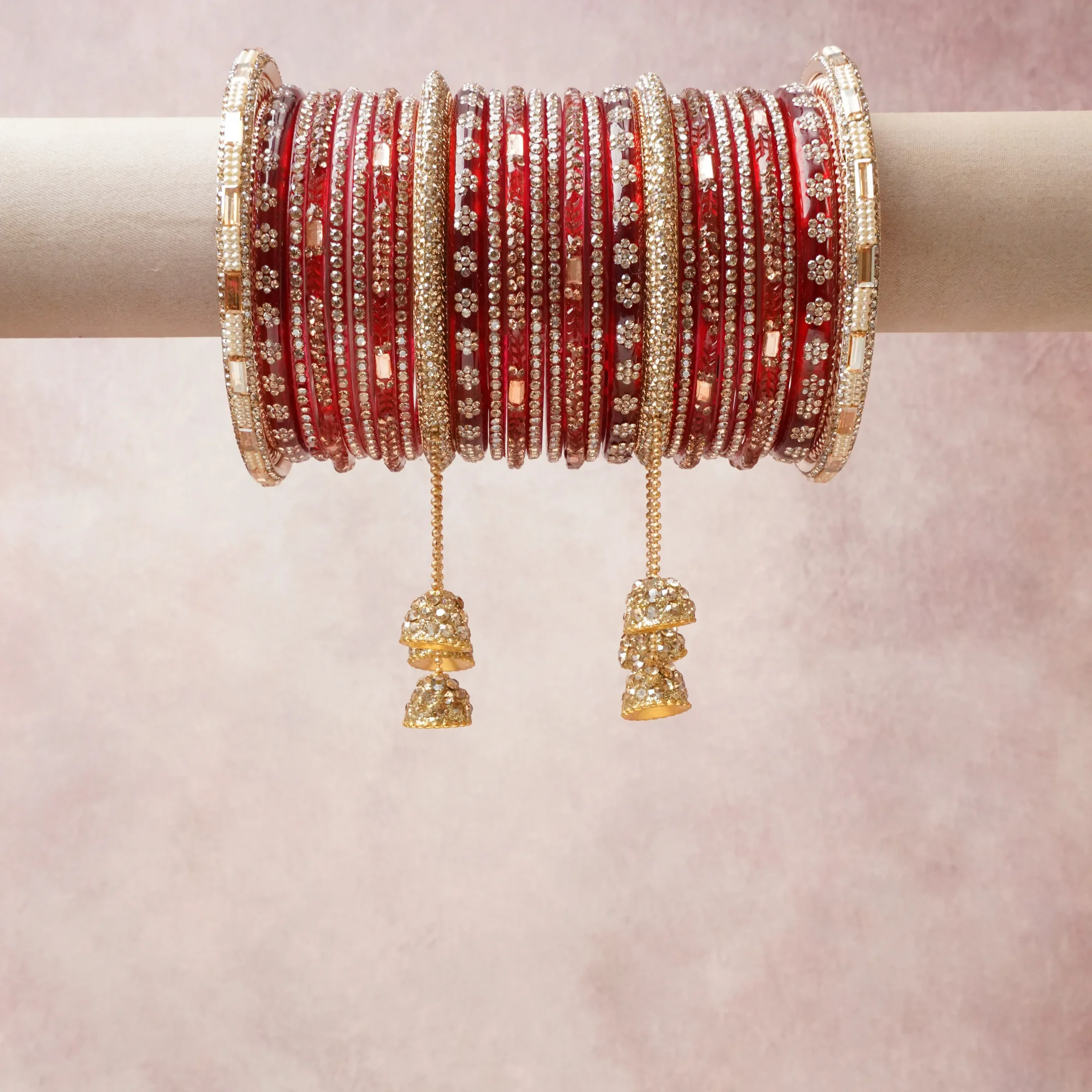 A commanding red anchors this beautiful set, enriched with accents of gold, white, rose gold that add depth and dimension.

Featuring a striking composition of glass bangles, gold-tone metal, rhinestones, this set carries intricate craftsmanship and strong presence. Grand in form, it is created for moments that deserve to be marked.