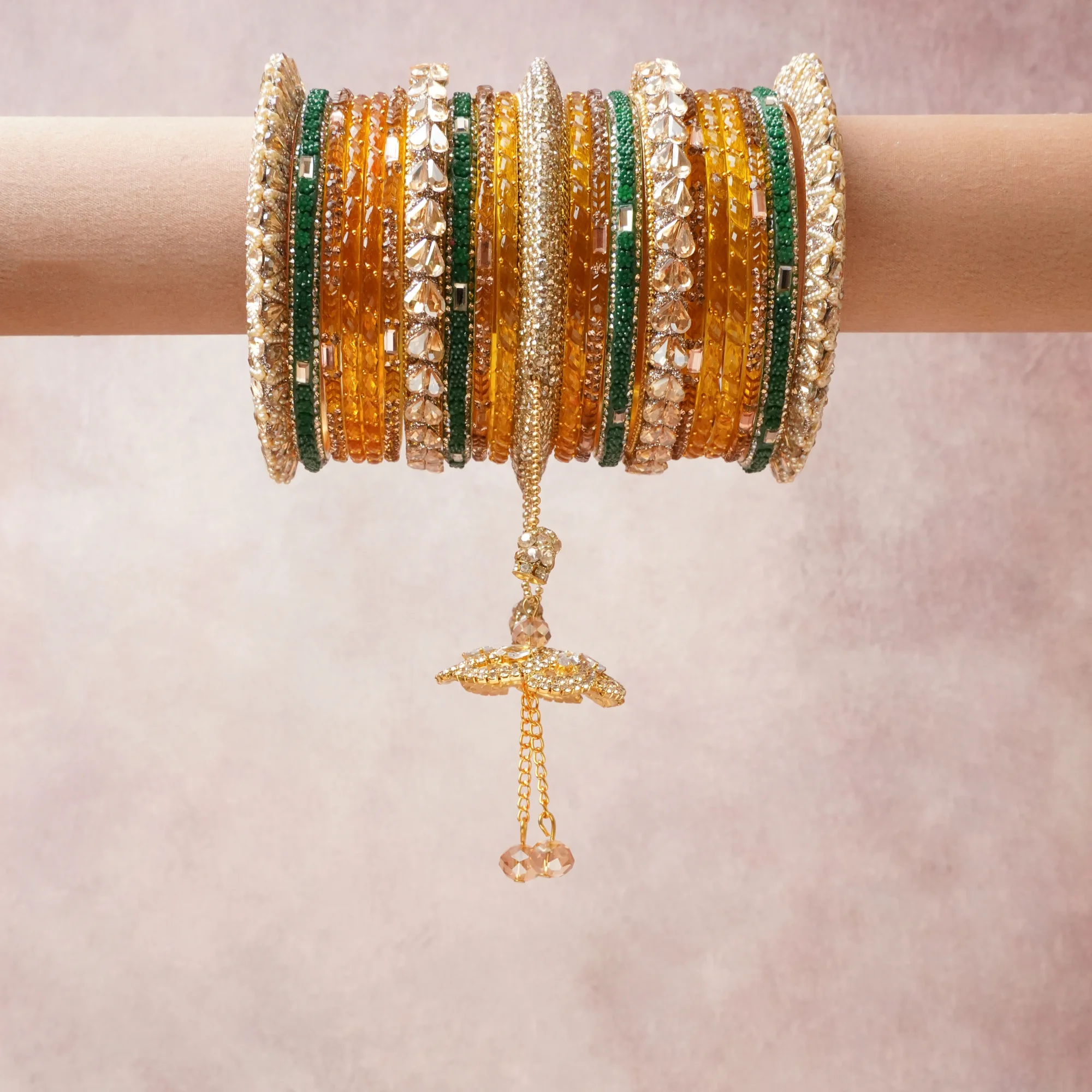 A commanding amber gold anchors this beautiful set, enriched with accents of emerald green, crystal clear, champagne gold that add depth and dimension.

Featuring a striking composition of glass beads and rhinestones, this set carries intricate craftsmanship and strong presence. Grand in form, it is created for moments that deserve to be marked.
