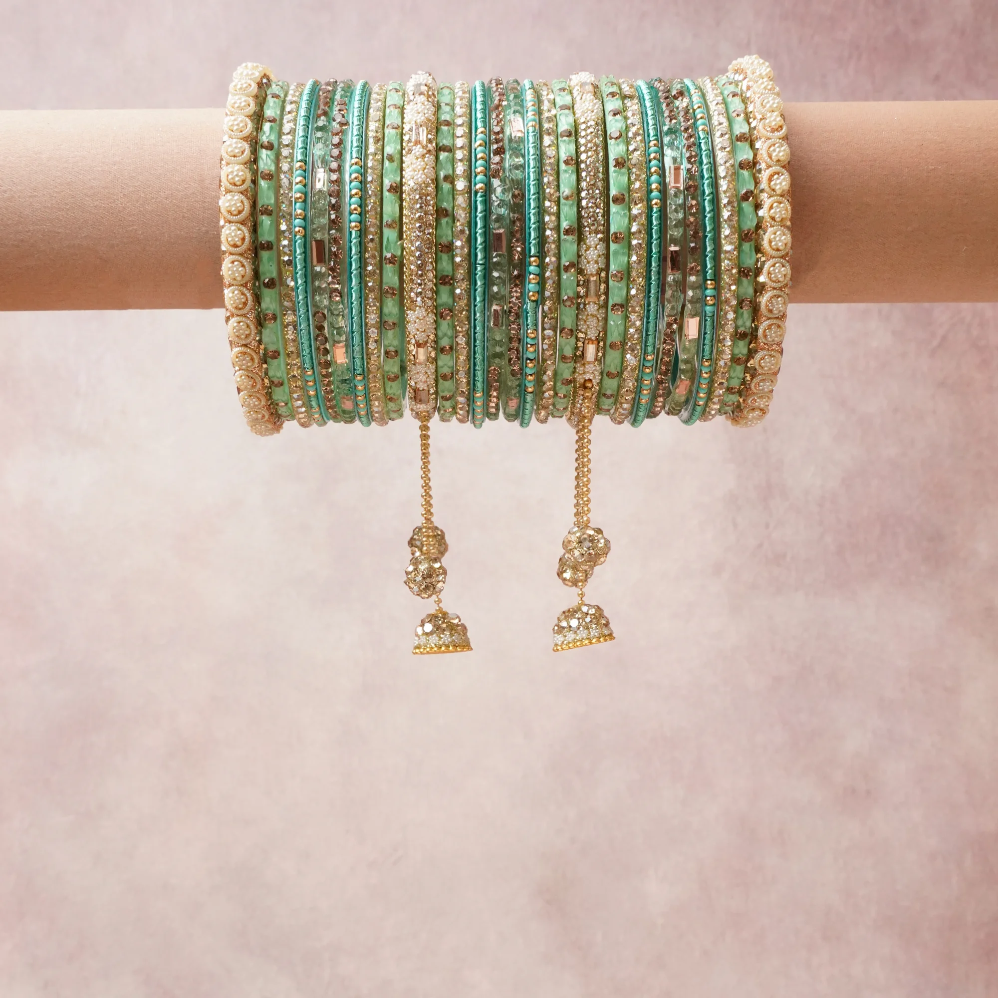 A commanding mint green anchors this beautiful set, enriched with accents of gold, ivory, turquoise that add depth and dimension.

Featuring a striking composition of kundan, enamel, gold-tone metal, this set carries intricate craftsmanship and strong presence. Grand in form, it is created for moments that deserve to be marked.