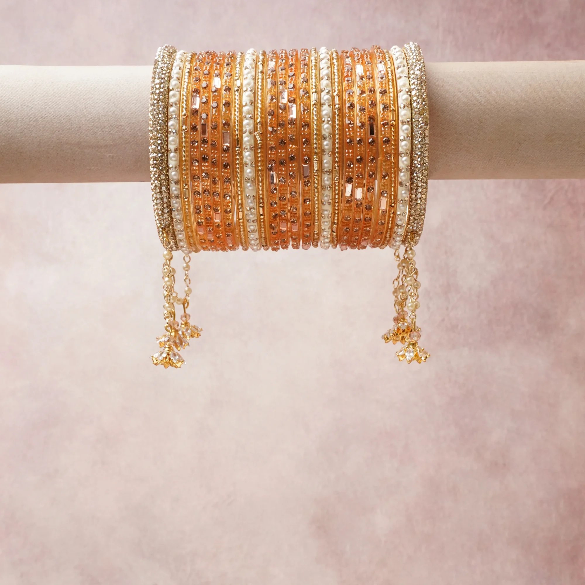 A commanding gold anchors this beautiful set, enriched with accents of white, champagne, orange that add depth and dimension.

Featuring a striking composition of glass beads, faux pearls, metal, this set carries intricate craftsmanship and strong presence. Grand in form, it is created for moments that deserve to be marked.