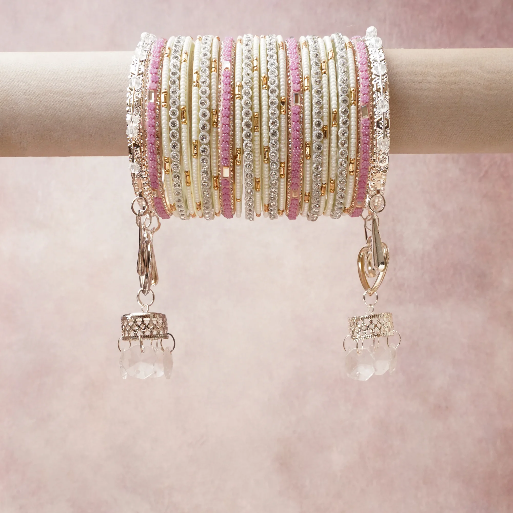 A commanding Silver anchors this beautiful set, enriched with accents of Blush Pink that add depth and dimension.

Featuring a striking composition of beaded glass, metal, crystal, this set carries intricate craftsmanship and strong presence. Grand in form, it is created for moments that deserve to be marked.