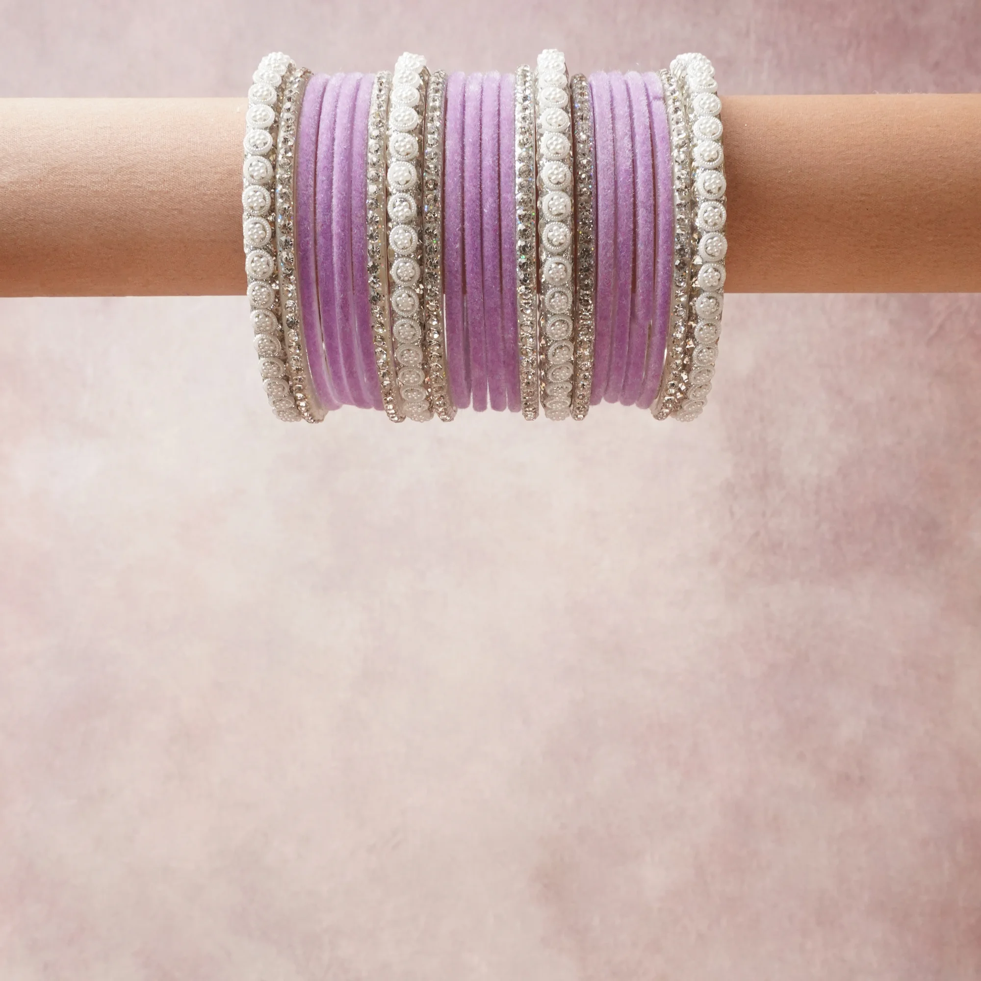 A grounding Lavender forms the heart of the set, while touches of Silver, White add charm.

A thoughtful composition of glass bangles, rhinestone metal bangle, designed to feel complete without being heavy.
Each element layers seamlessly, creating a look that is refined, wearable and quietly striking.