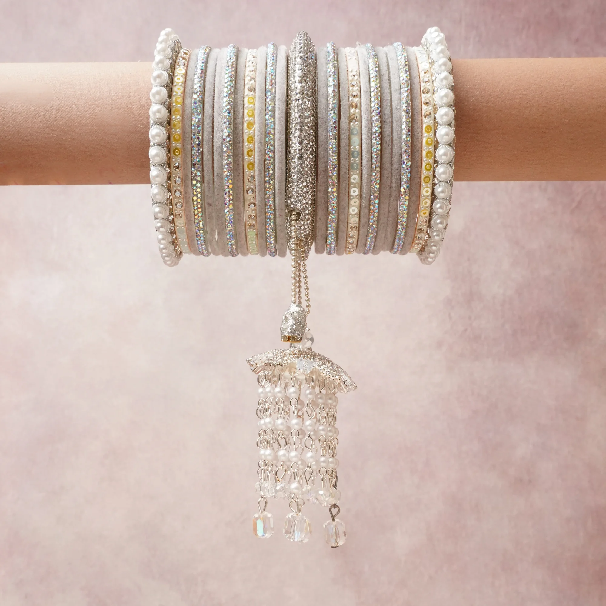 A commanding Silver anchors this beautiful set, enriched with accents of Champagne Gold, White that add depth and dimension.

Featuring a striking composition of crystals, pearls, rhinestones, metallic thread, this set carries intricate craftsmanship and strong presence. Grand in form, it is created for moments that deserve to be marked.