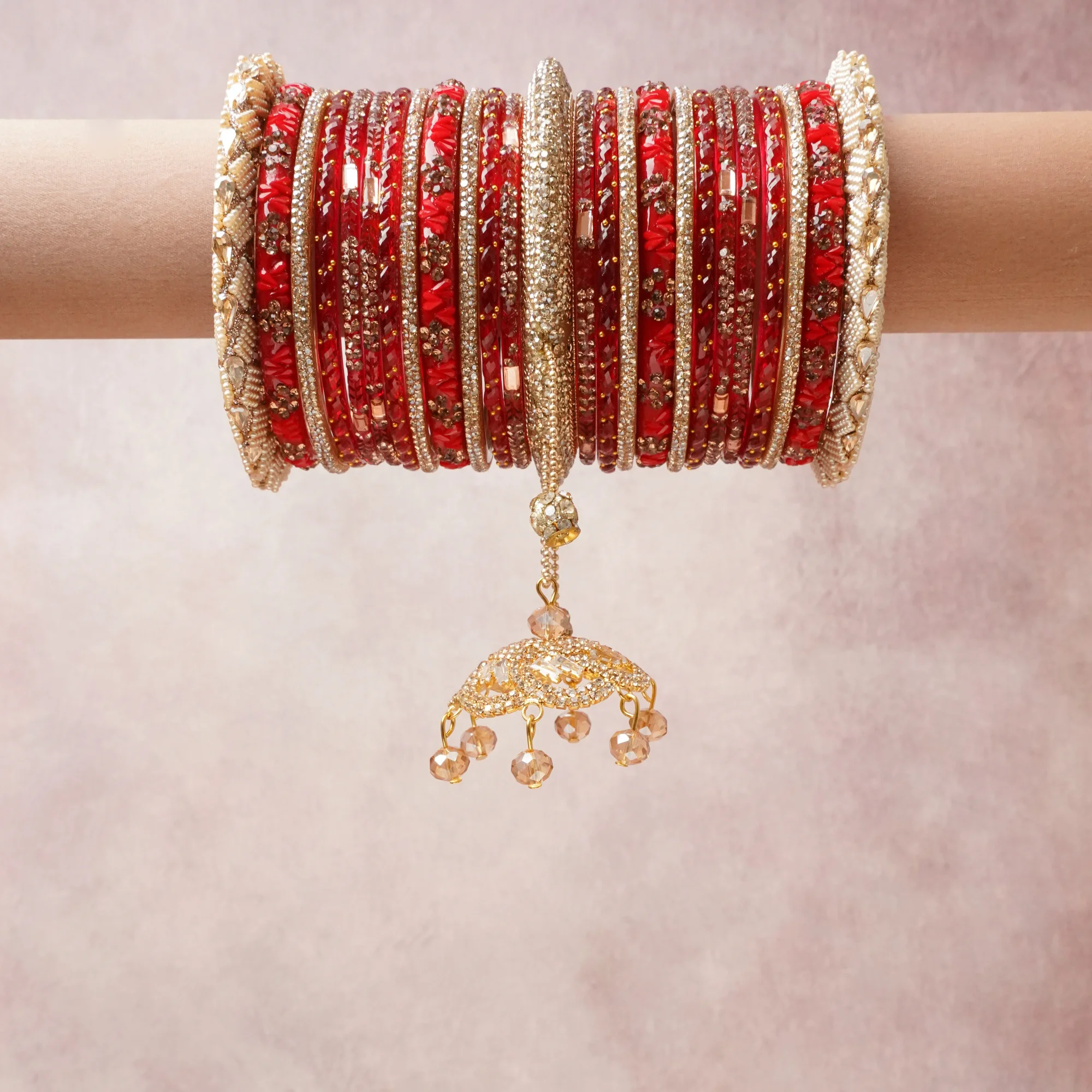 A commanding Red anchors this beautiful set, enriched with accents of Gold, Champagne that add depth and dimension.

Featuring a striking composition of glass bangles, rhinestones, metal, this set carries intricate craftsmanship and strong presence. Grand in form, it is created for moments that deserve to be marked.
