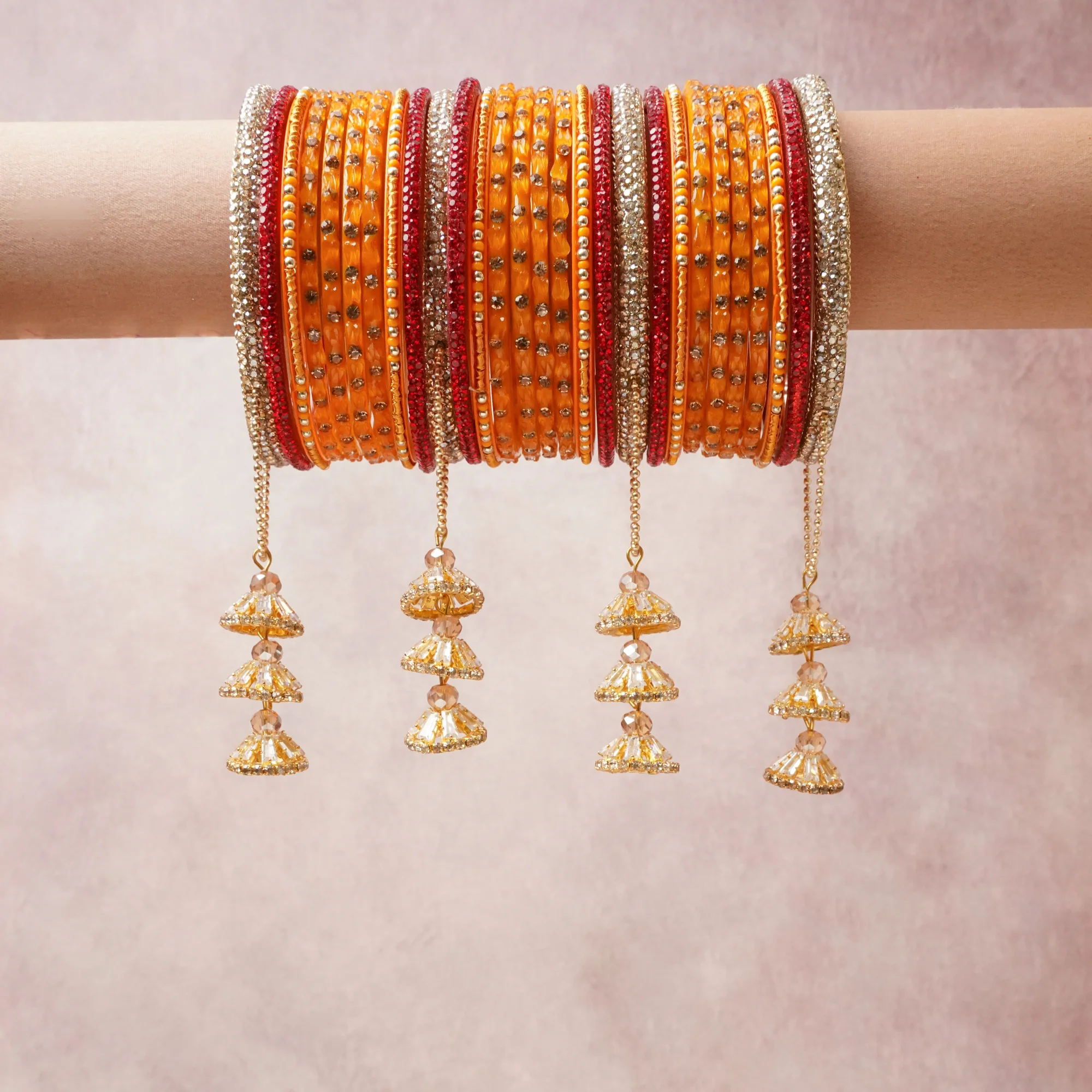 A commanding Orange anchors this beautiful set, enriched with accents of Red, Gold that add depth and dimension.

Featuring a striking composition of embellished glass bangles, rhinestones, metal, this set carries intricate craftsmanship and strong presence. Grand in form, it is created for moments that deserve to be marked.