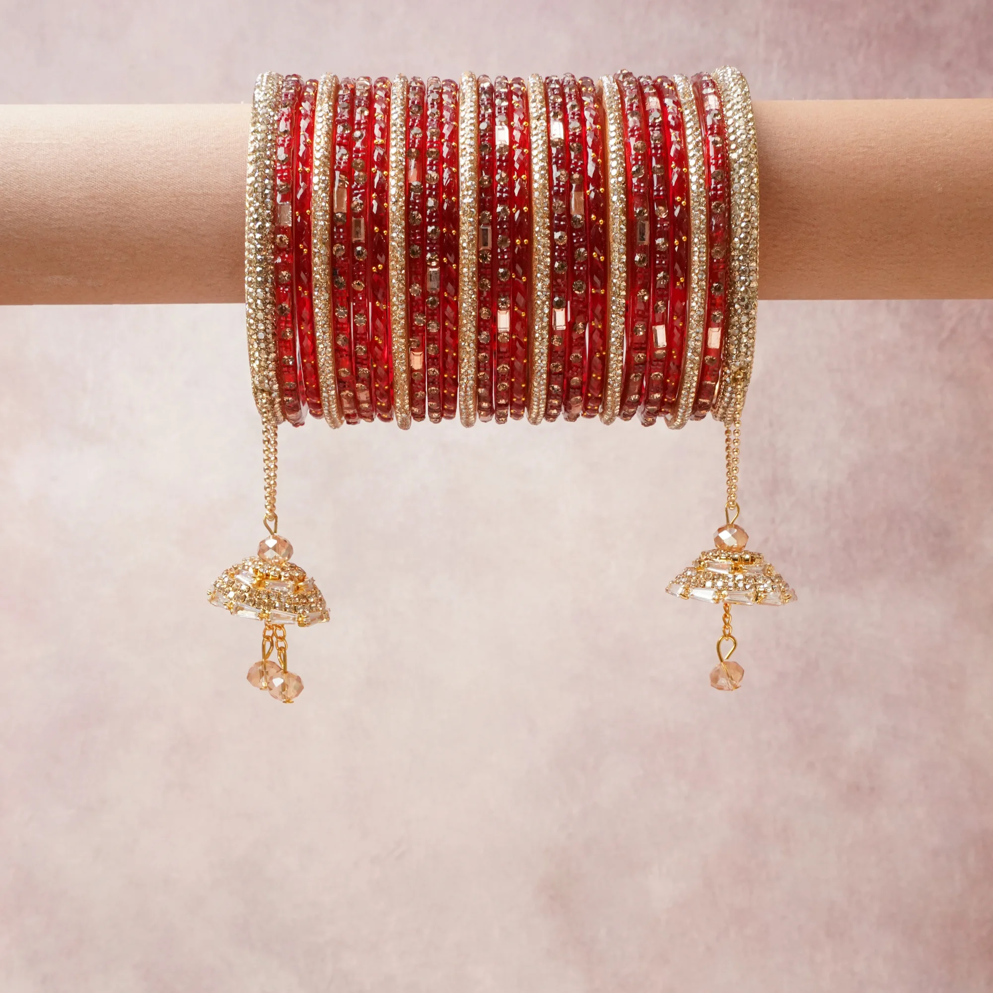 A commanding Red anchors this beautiful set, enriched with accents of Gold that add depth and dimension.

Featuring a striking composition of Glass bangles, rhinestones, gold-tone metal, this set carries intricate craftsmanship and strong presence. Grand in form, it is created for moments that deserve to be marked.
