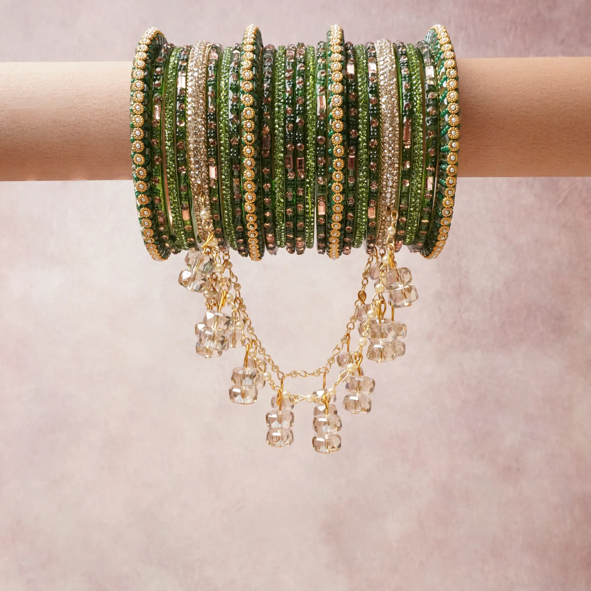 A commanding Emerald Green anchors this beautiful set, enriched with accents of Gold, Champagne that add depth and dimension.

Featuring a striking composition of glass bangles, crystal, this set carries intricate craftsmanship and strong presence. Grand in form, it is created for moments that deserve to be marked.